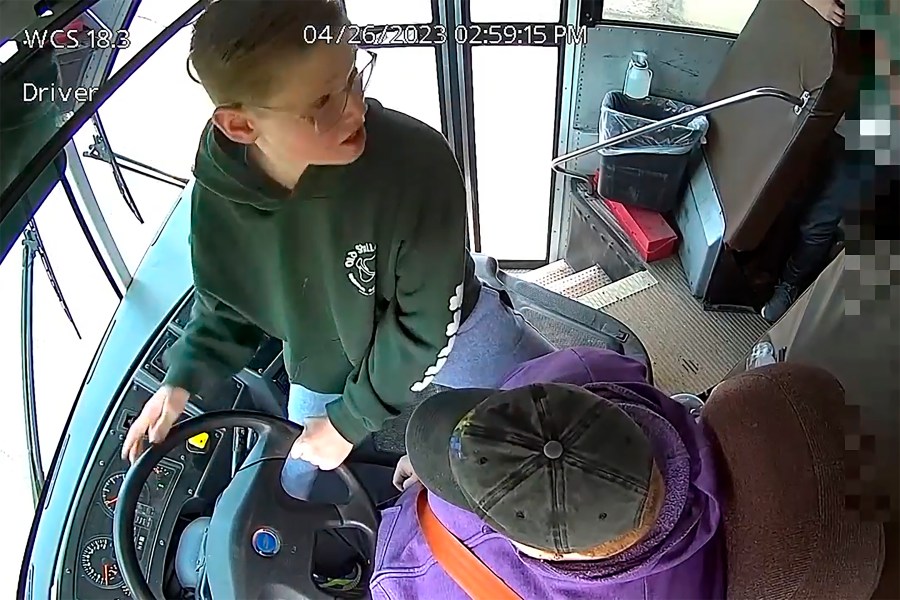 In this image made from video, seventh-grader Dillon Reeves grabs the steering wheel on his school bus and hit the brakes after the driver passed out Wednesday, April 28, 2023, Warren, Mi. Warren Consolidated Schools Superintendent Robert Livernois is calling it an “extraordinary act of courage.” (Warren Consolidated Schools via AP)