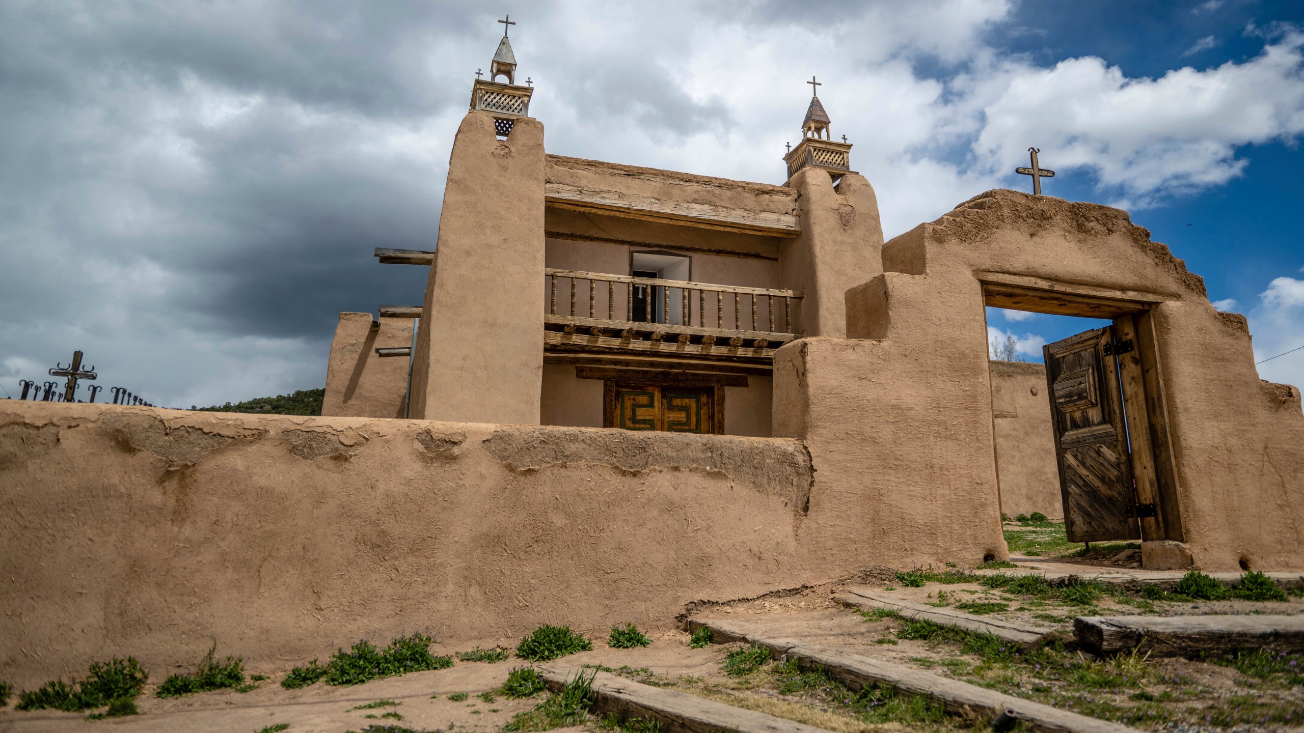 An exterior view of the San Jose de Gracia Catholic Church, built in 1760, in Las Trampas, New Mexico, Friday, April 14, 2023. Threatened by depopulation, dwindling congregations and fading traditions, some faithful are fighting to save their historic adobe churches and the uniquely New Mexican way of life they represent. (AP Photo/Roberto E. Rosales)