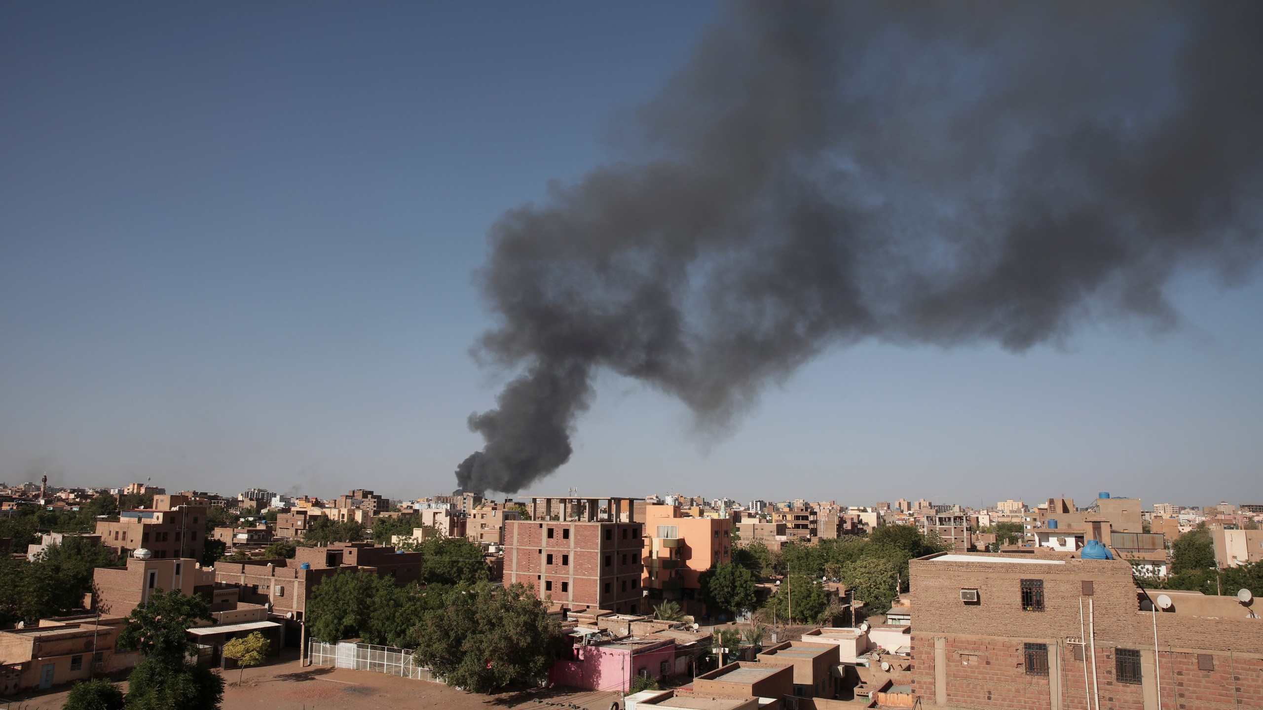 FILE - Smoke is seen in Khartoum, Sudan, Wednesday, April 19, 2023. The U.S. conducted its first organized evacuation of citizens and permanent residents from Sudan, the State Department said Saturday, April 29, two weeks into a conflict that has turned Khartoum into a war zone and thrown the country into turmoil. American unmanned aircraft, which have been keeping an eye on overland evacuation routes for days, were providing armed overwatch for the American operation, according to two people briefed on the operation who were not authorized to speak publicly. (AP Photo/Marwan Ali, File)