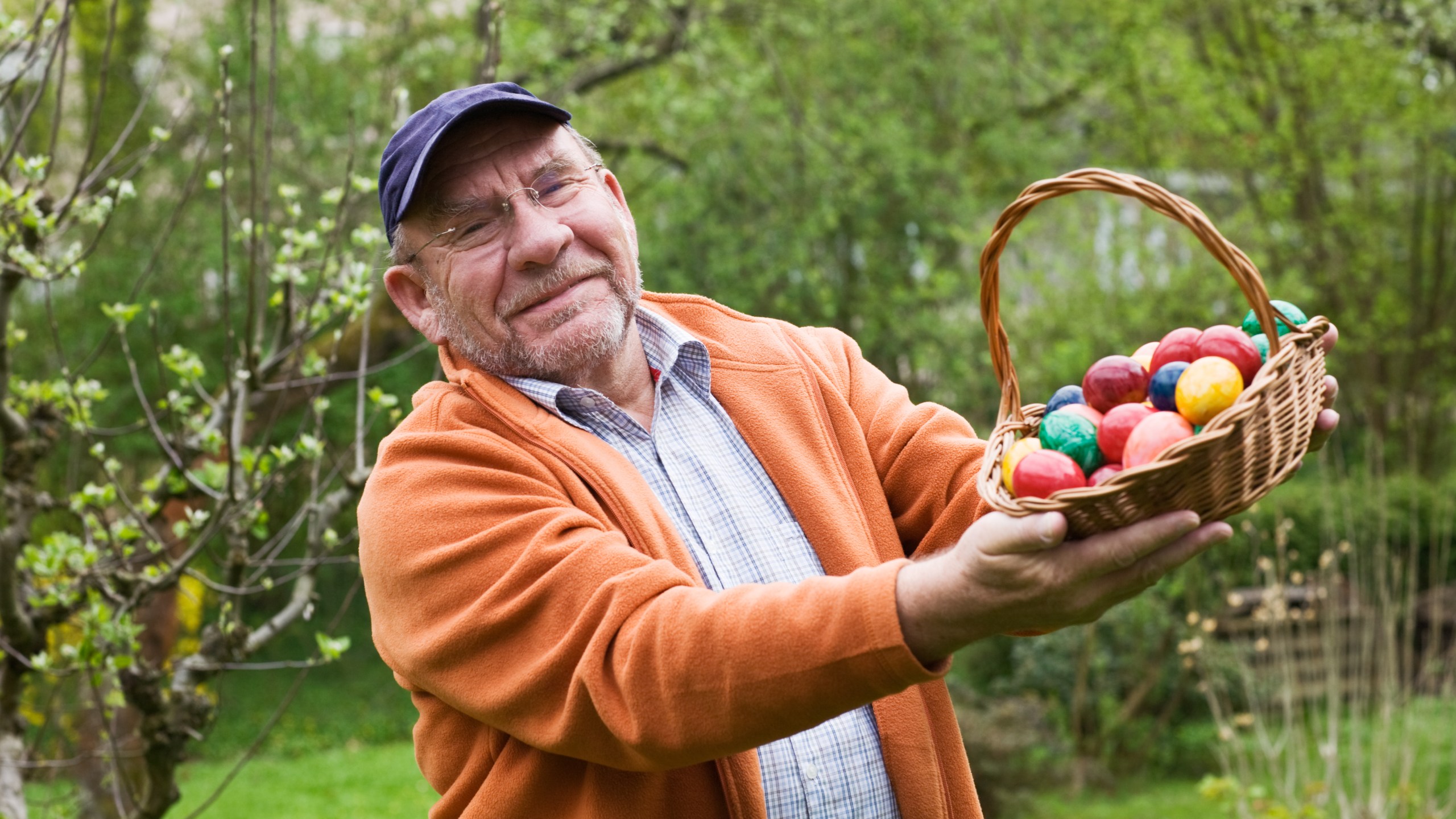 Man holds basket of Easter eggs (Getty image)