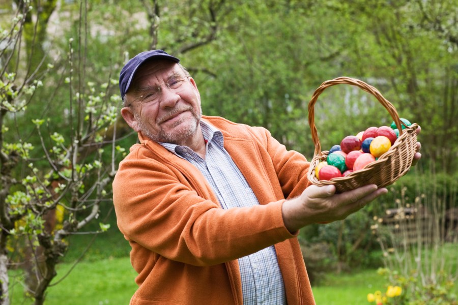 Man holds basket of Easter eggs (Getty image)