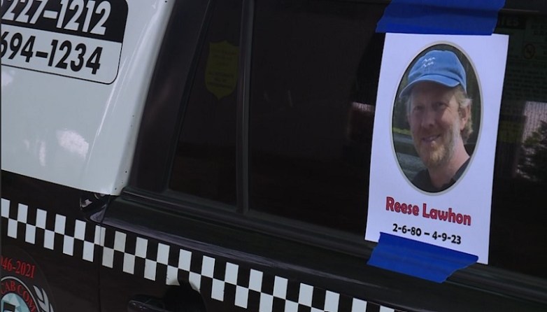 A photo is taped to the window of a Radio Cab during the public memorial for Radio Cab driver Reese Lawhon, April 22, 2023 (KOIN)