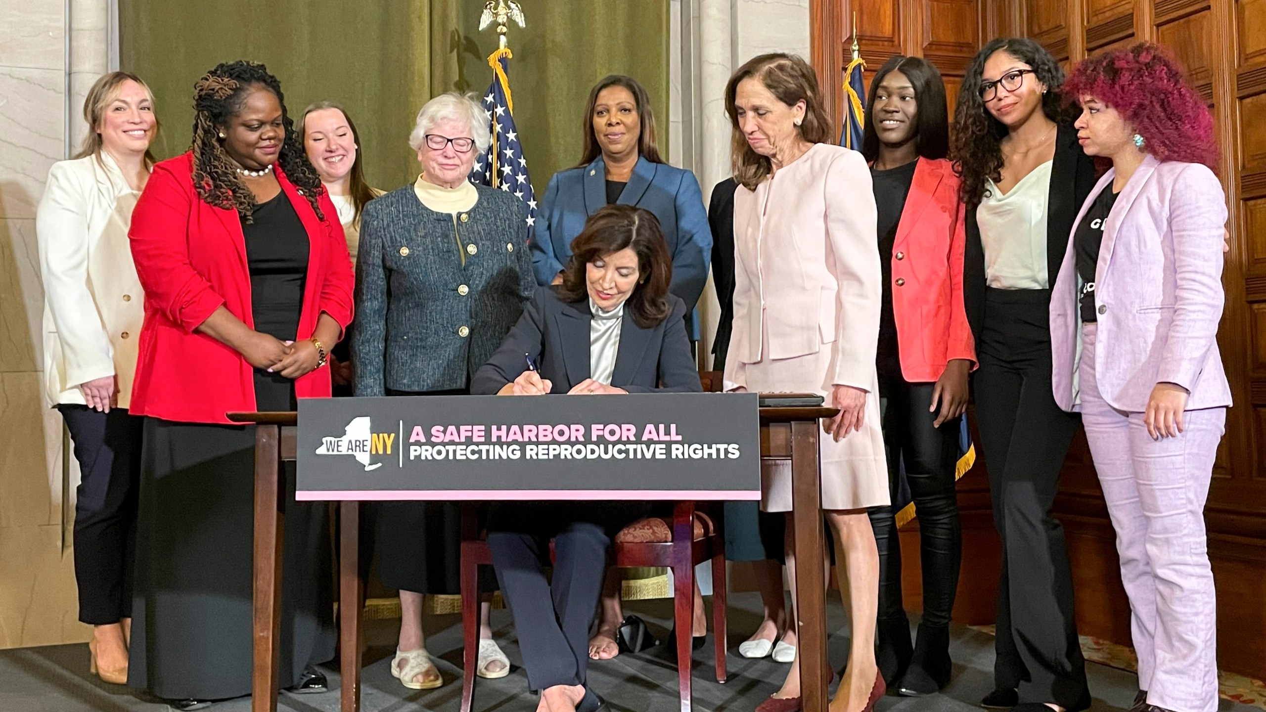 New York Gov. Kathy Hochul, center, signs bills expanding reproductive healthcare that will allow people in New York to receive contraceptives without a doctor's prescription, Tuesday, May 2, 2023, in Albany, N.Y. Under the new law that will go into effect next year, pharmacists will be able to distribute self-administered hormonal contraceptives including oral birth control pills, vaginal rings, and the patch.(AP Photo/Maysoon Khan)