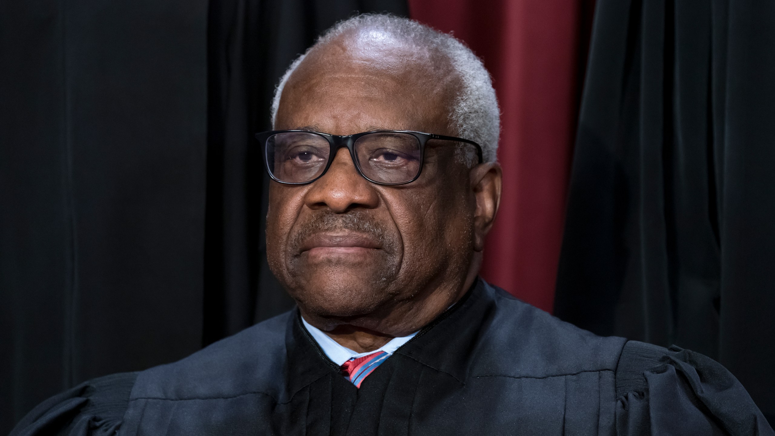 FILE - Associate Justice Clarence Thomas joins other members of the Supreme Court as they pose for a new group portrait, at the Supreme Court building in Washington, Oct. 7, 2022. A Republican megadonor paid two years of private school tuition for a child raised by Supreme Court Justice Clarence Thomas, who did not disclose the payments, a lawyer who has represented Thomas and his wife acknowledged Thursday. (AP Photo/J. Scott Applewhite, File)