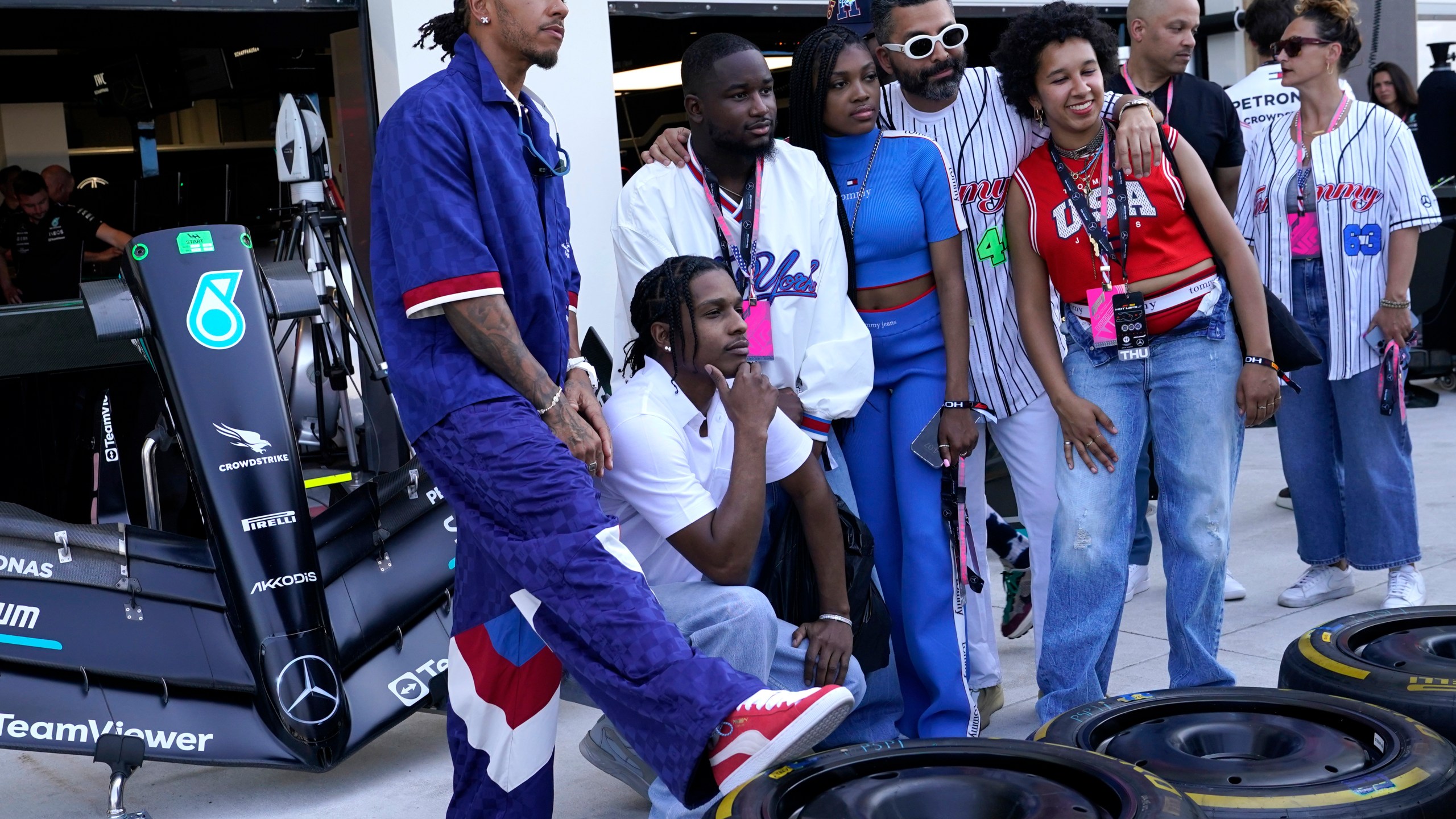 Mercedes driver Lewis Hamilton, left, of Britain, poses for a photo with A$AP Rocky, second from left, in the pit lane ahead of the Formula One Miami Grand Prix auto race at Miami International Autodrome, Thursday, May 4, 2023, in Miami Gardens, Fla. (AP Photo/Lynne Sladky)