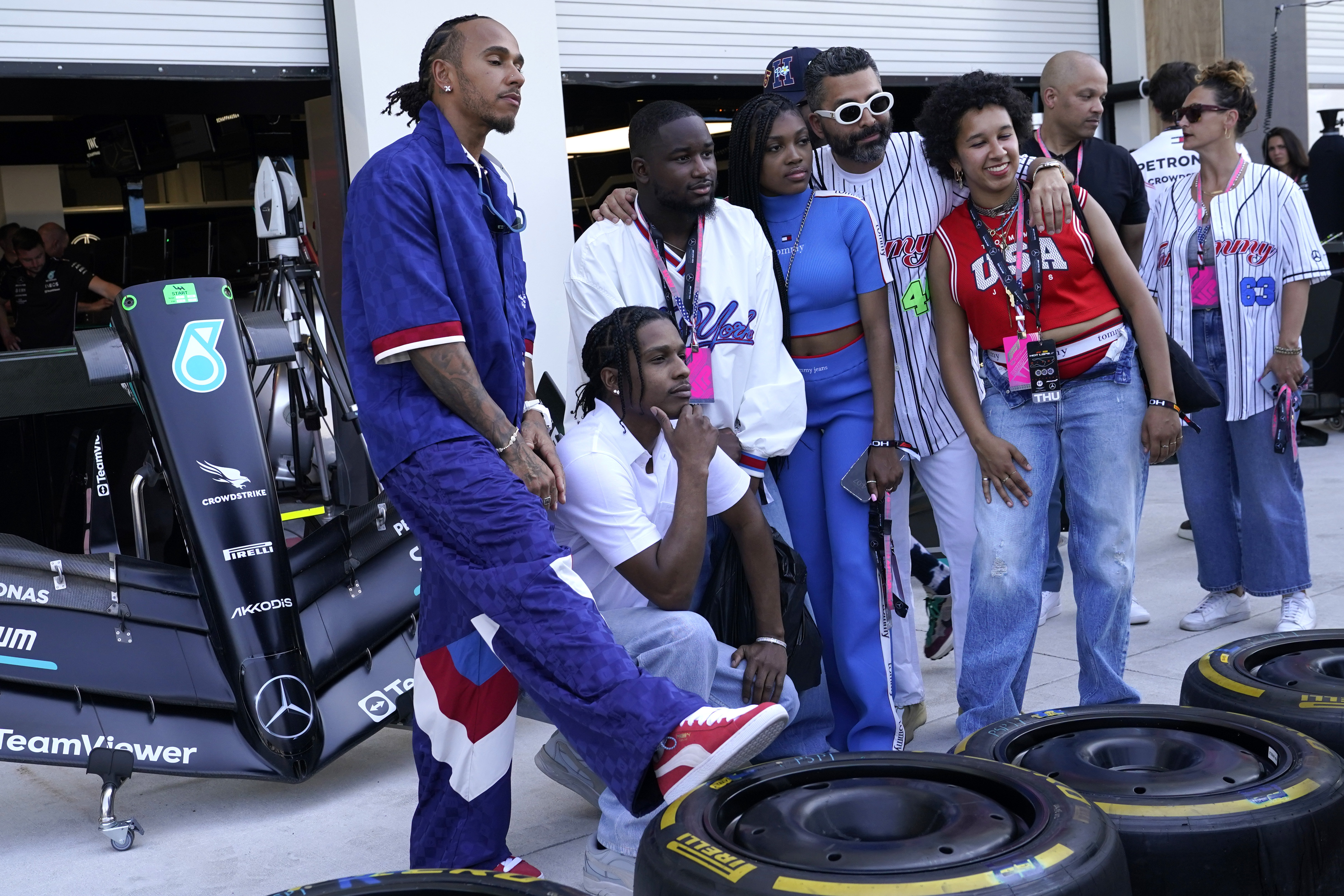 Mercedes driver Lewis Hamilton, left, of Britain, poses for a photo with A$AP Rocky, second from left, in the pit lane ahead of the Formula One Miami Grand Prix auto race at Miami International Autodrome, Thursday, May 4, 2023, in Miami Gardens, Fla. (AP Photo/Lynne Sladky)