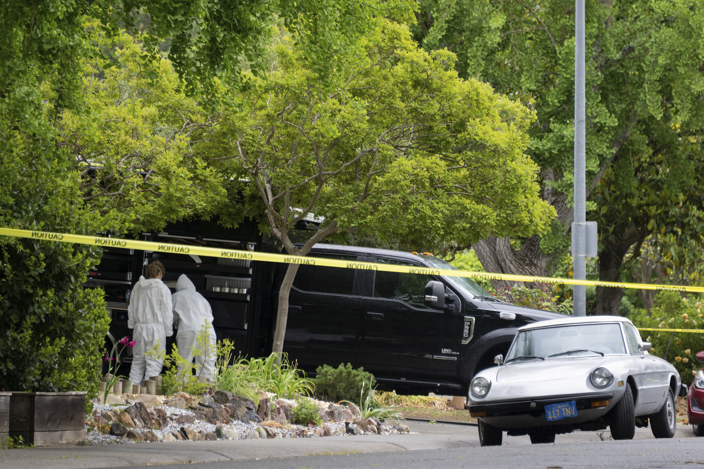 Police investigators are seen at the home of stabbing suspect Carlos Dominguez, 21, on Hawthorn Lane in Davis, Calif., on Thursday, May 4, 2023. A 21-year-old who had been a student at the University of California, Davis, until last week was arrested for allegedly stabbing three people, including two fatally, and sending fear through the quiet college community, city police said. Davis Police Chief Darren Pytel said Dominguez was taken into custody after 15 people called in reports of a person who matched the description of the suspect in a local park. (Paul Kitagaki Jr./The Sacramento Bee via AP)