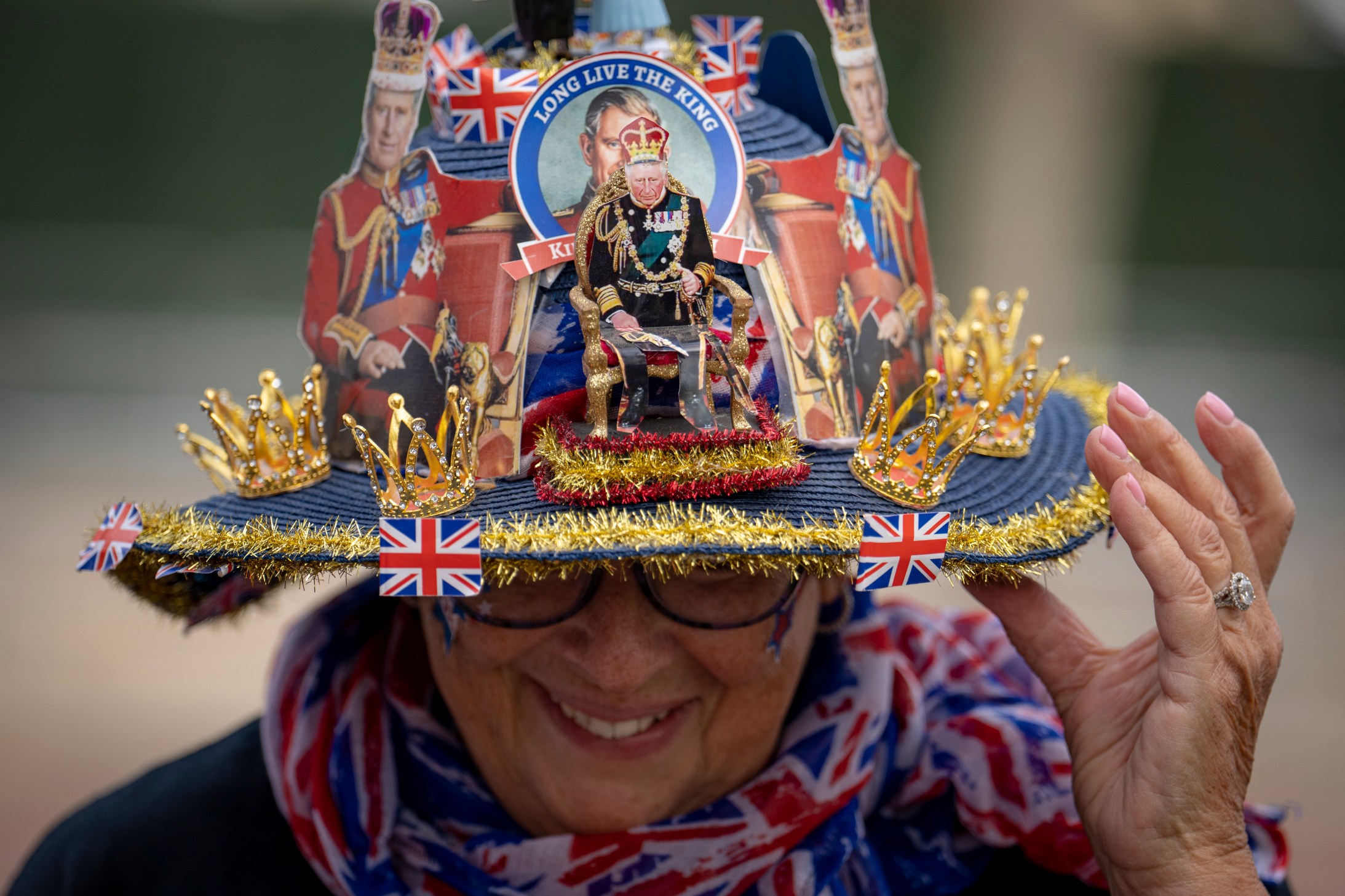 Royal enthusiast Donna Werner of the United States shows off the hat she made, while camping on the Mall, a part of the royal procession route, in central London, Thursday, May 4, 2023. The Coronation of King Charles III will take place at Westminster Abbey on May 6. (AP Photo/Vadim Ghirda)