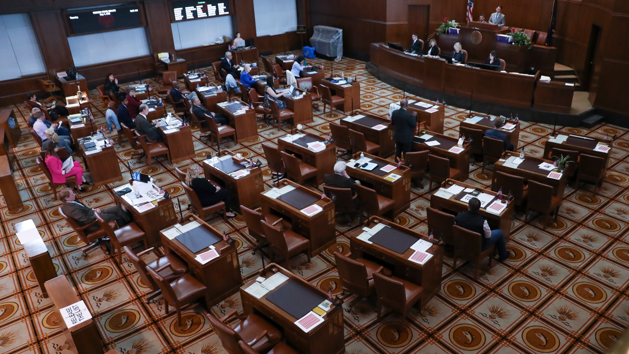 Senators sit at their desks during a session at the Oregon State Capitol in Salem, Ore., Thursday, May 4, 2023. Four Republican senators and one Independent senator had unexcused absences, preventing a quorum for the second day. (AP Photo/Amanda Loman)