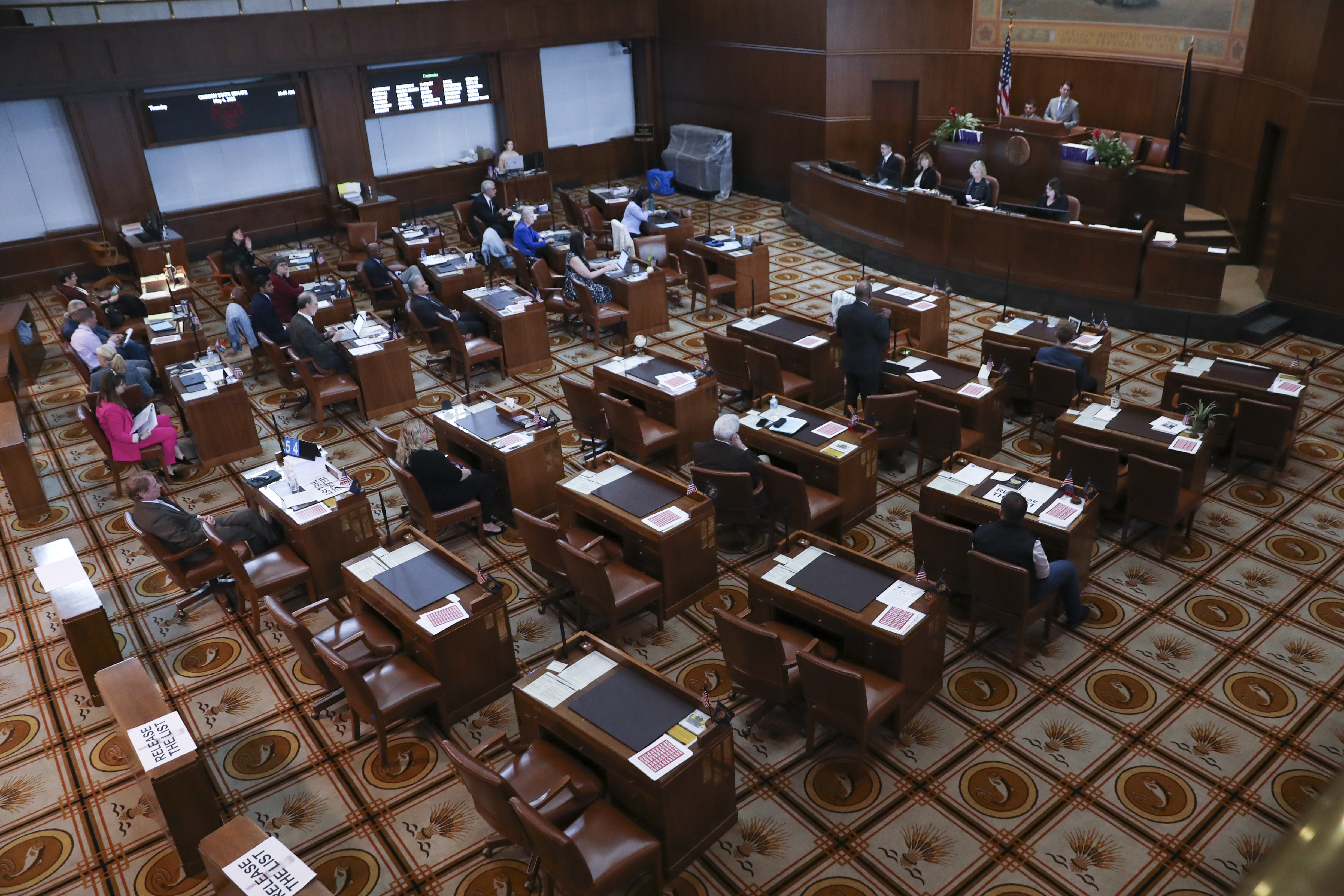 Senators sit at their desks during a session at the Oregon State Capitol in Salem, Ore., Thursday, May 4, 2023. Four Republican senators and one Independent senator had unexcused absences, preventing a quorum for the second day. (AP Photo/Amanda Loman)