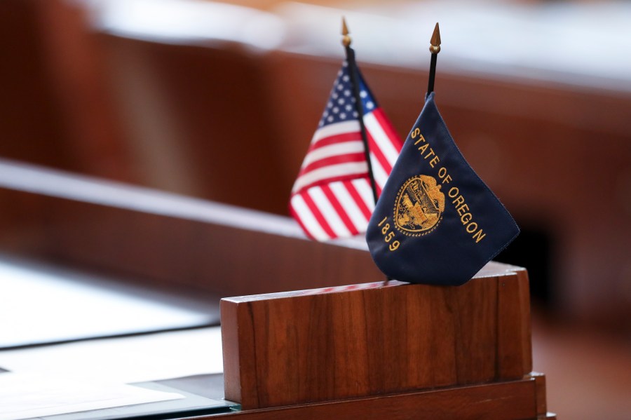 Flags sit on a desk belonging Republican state Sen. Lynn Findley in the Oregon Senate prior to a legislative session at the Oregon State Capitol in Salem, Ore., Friday, May 5, 2023. Sen. Findley, along with three other Republican senators and one Independent senator had unexcused absences during two prior sessions, preventing a quorum. (AP Photo/Amanda Loman)