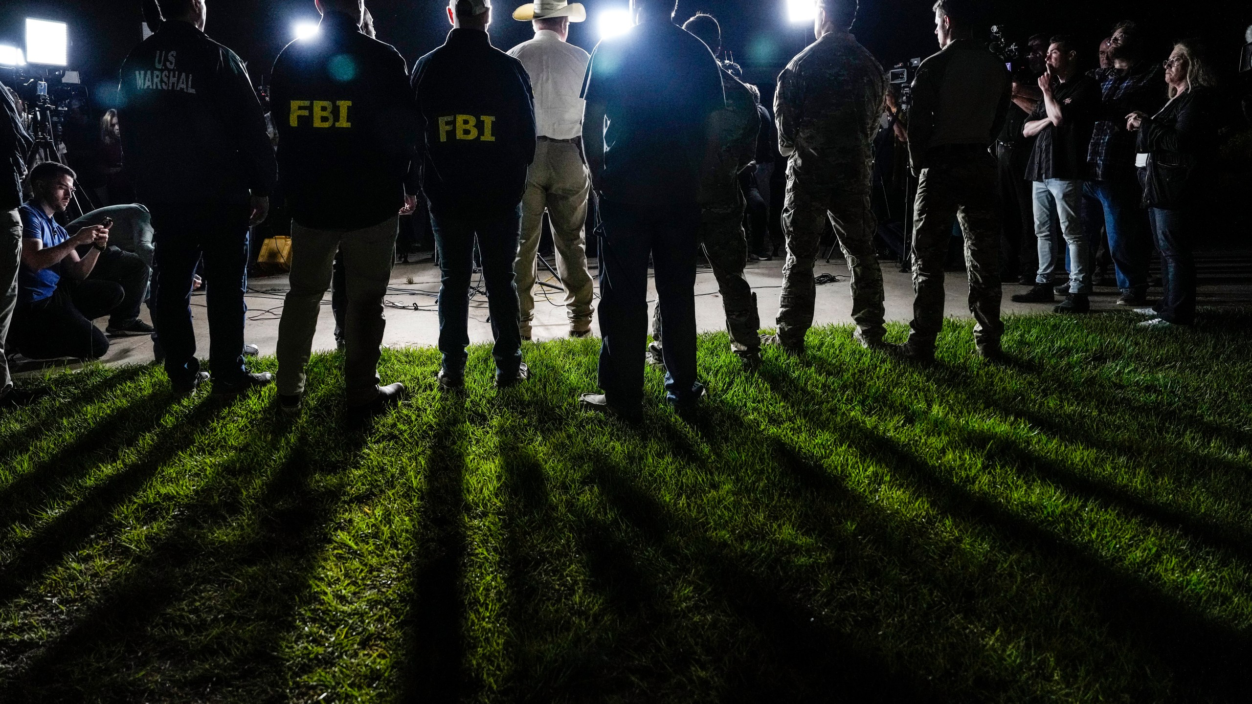 San Jacinto County Sheriff Greg Capers speaks to the media surrounded by law enforcement officers during a news conference announcing the arrest of murder suspect Francisco Oropeza on Tuesday, May 2, 2023, in Cleveland, Texas. Law enforcement officials captured Oropeza without incident on Tuesday night at a home near Houston, ending a four-day manhunt for a suspect who police believe fled after a mass shooting that left five dead. (Brett Coomer/Houston Chronicle via AP)