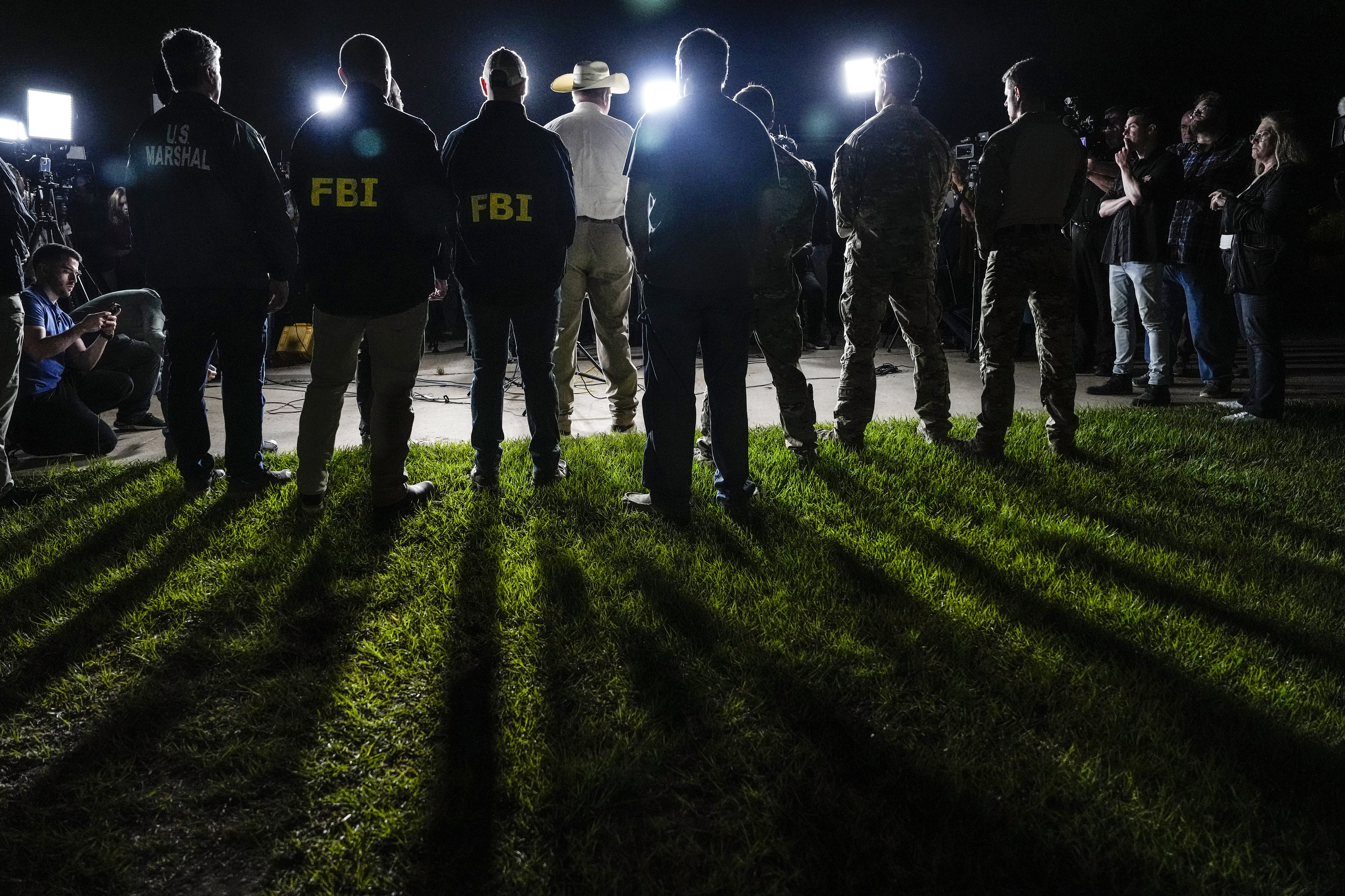 San Jacinto County Sheriff Greg Capers speaks to the media surrounded by law enforcement officers during a news conference announcing the arrest of murder suspect Francisco Oropeza on Tuesday, May 2, 2023, in Cleveland, Texas. Law enforcement officials captured Oropeza without incident on Tuesday night at a home near Houston, ending a four-day manhunt for a suspect who police believe fled after a mass shooting that left five dead. (Brett Coomer/Houston Chronicle via AP)