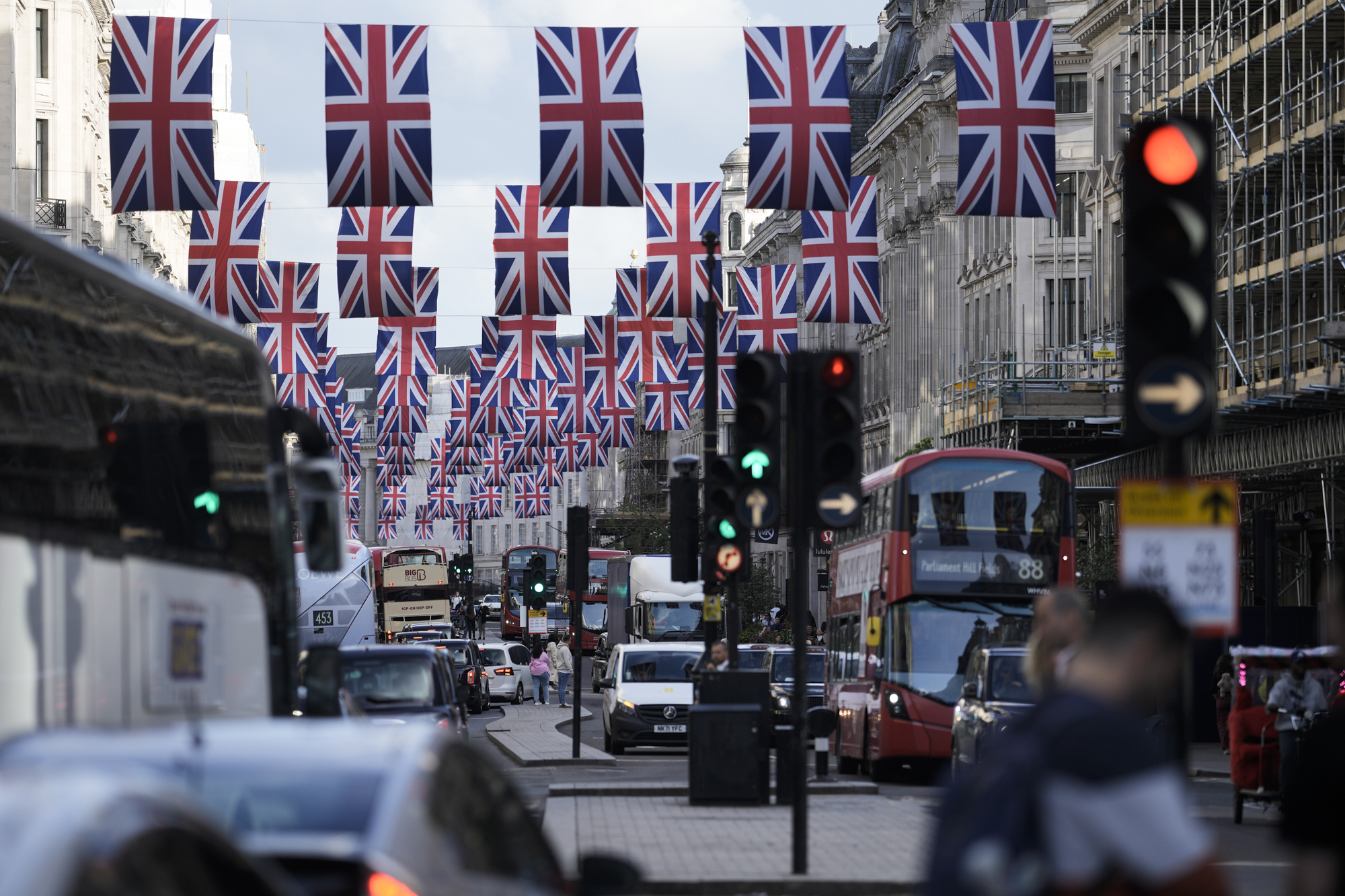 Traffic moves through the decorated Regent Street in central London Friday, May 5, 2023. The Coronation of King Charles III will take place at Westminster Abbey on May 6. (AP Photo/Markus Schreiber)