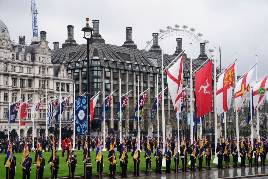 Standard bearers and members of the military in Parliament Square, ahead of the coronation ceremony of King Charles III at Westminster Abbey, London, Saturday, May 6, 2023. (Jane Barlow/Pool Photo via AP)