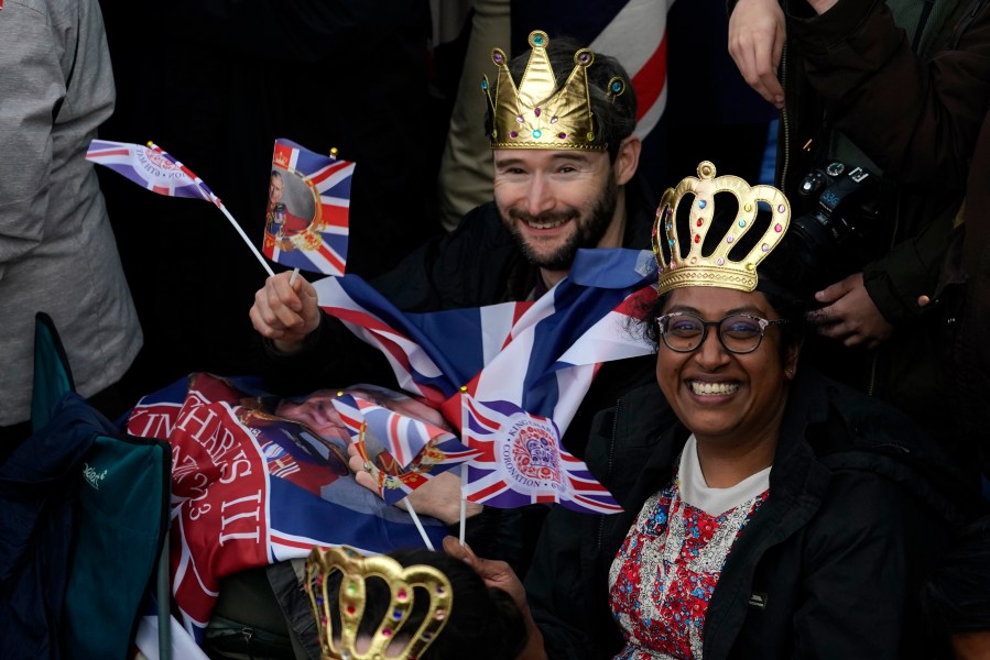 Royal fans take their seats where they can watch the procession of the coronation of Britain's King Charles III in London Saturday, May 6, 2023. (AP Photo/Alberto Pezzali)