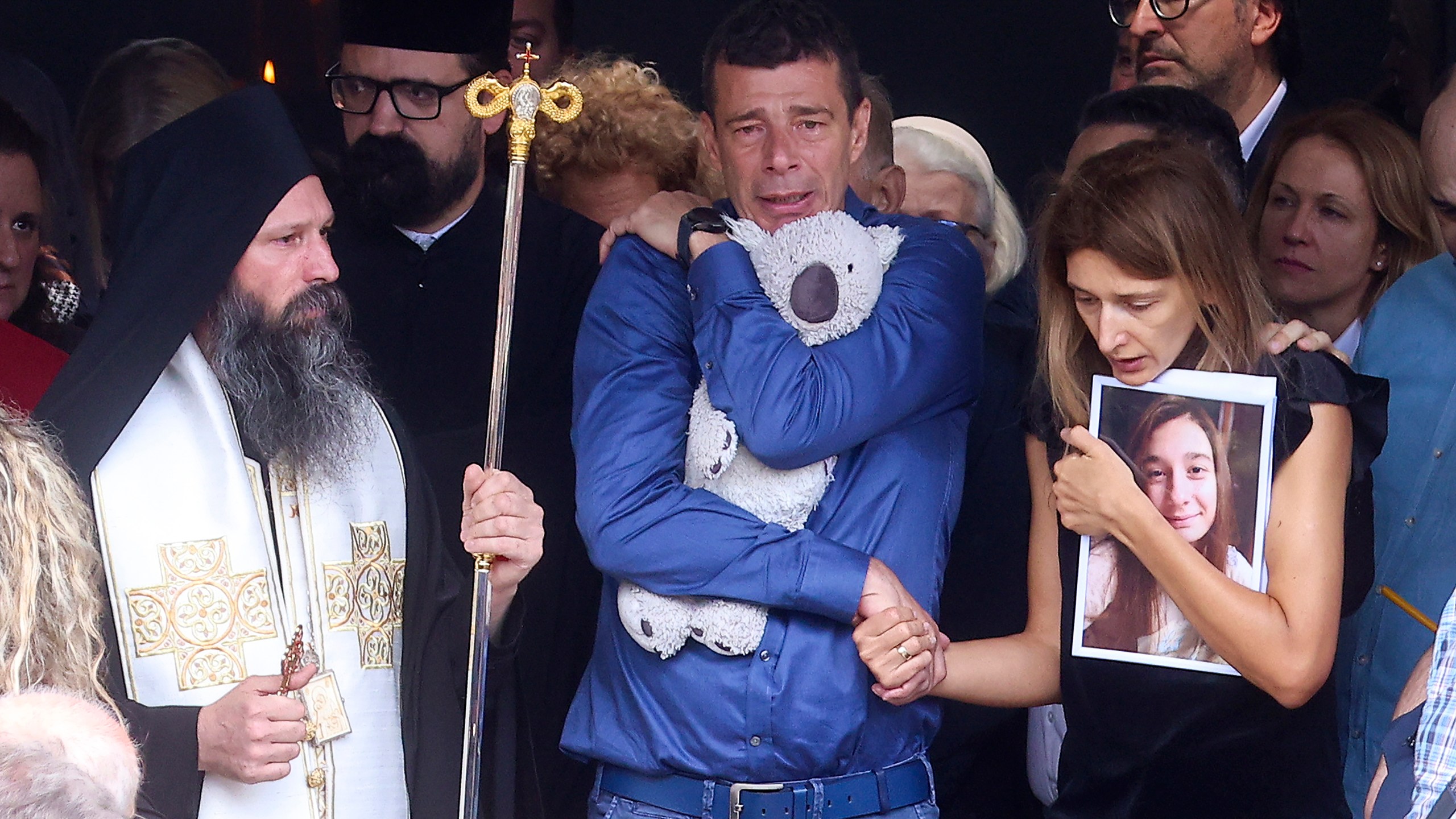 Parents of Ema Kobiljski, 13, mourn during the funeral procession at the central cemetery in Belgrade, Serbia, Saturday, May 6, 2023. Her schoolmate, a 13-year-old boy, on Wednesday, used his father's guns to kill eight fellow students and a guard. (AP Photo/Armin Durgut)