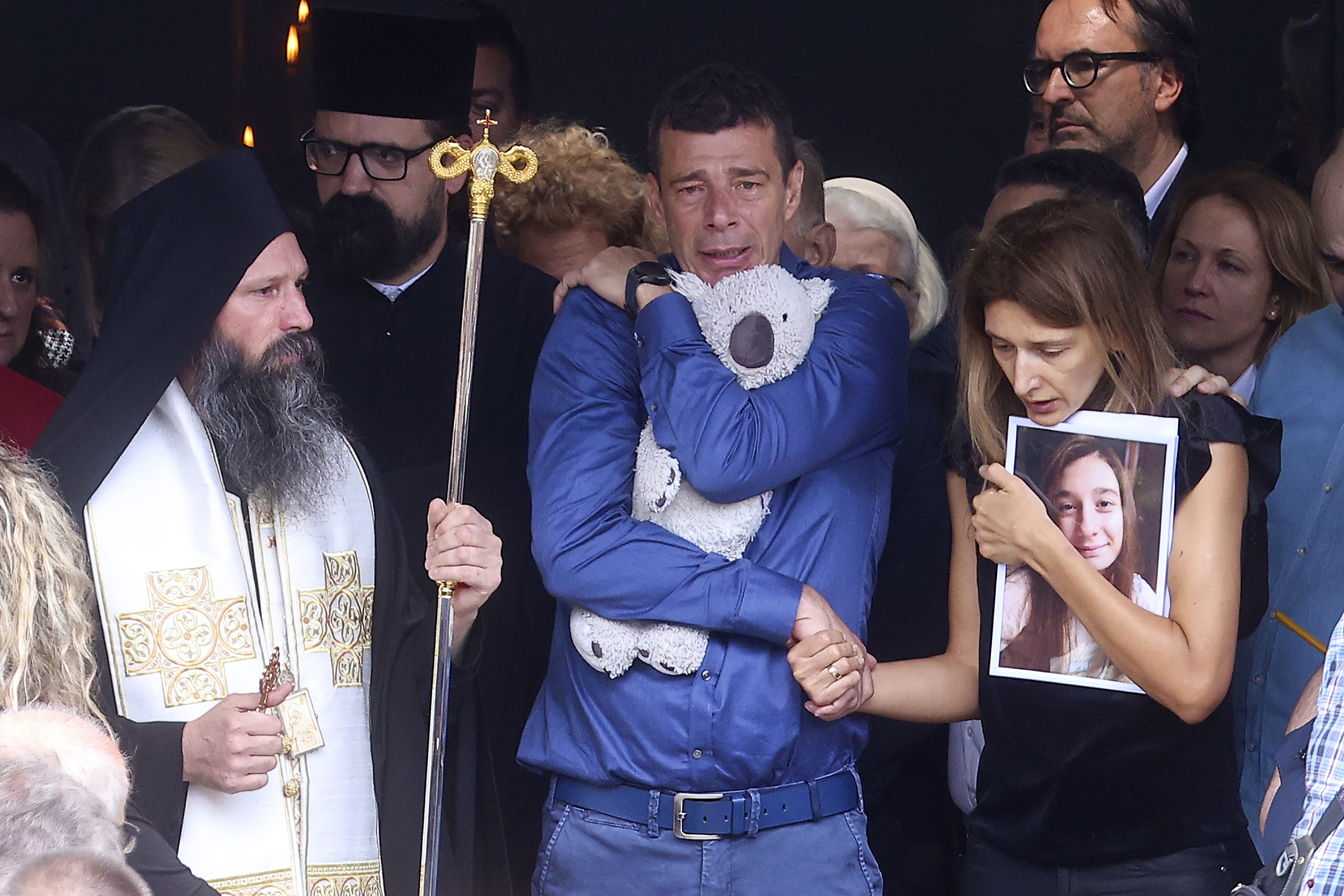 Parents of Ema Kobiljski, 13, mourn during the funeral procession at the central cemetery in Belgrade, Serbia, Saturday, May 6, 2023. Her schoolmate, a 13-year-old boy, on Wednesday, used his father's guns to kill eight fellow students and a guard. (AP Photo/Armin Durgut)