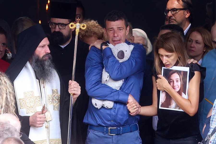 Parents of Ema Kobiljski, 13, mourn during the funeral procession at the central cemetery in Belgrade, Serbia, Saturday, May 6, 2023. Her schoolmate, a 13-year-old boy, on Wednesday, used his father's guns to kill eight fellow students and a guard. (AP Photo/Armin Durgut)