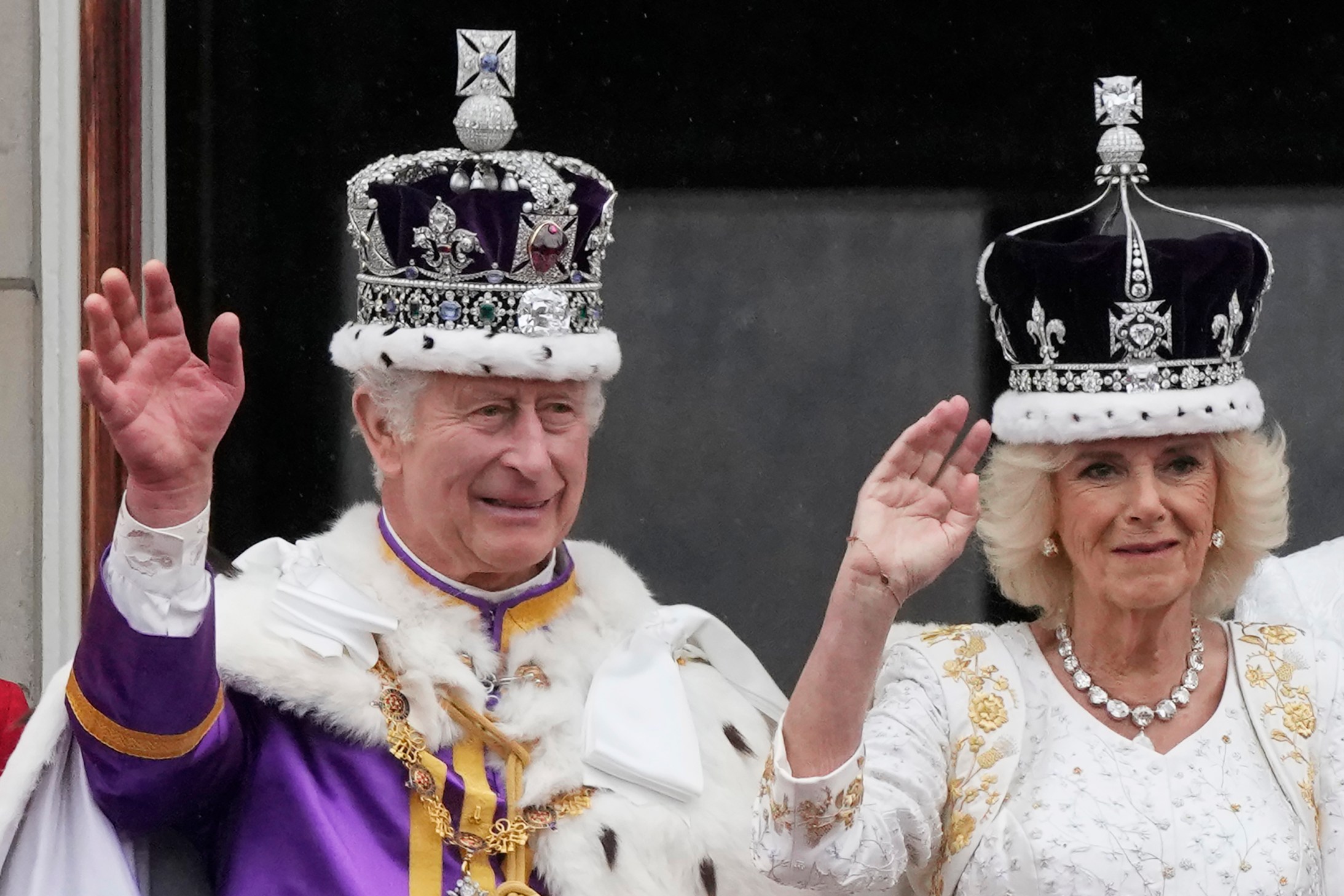 Britain's King Charles III and Queen Camilla wave to the crowds from the balcony of Buckingham Palace after the coronation ceremony in London, Saturday, May 6, 2023. (AP Photo/Frank Augstein)