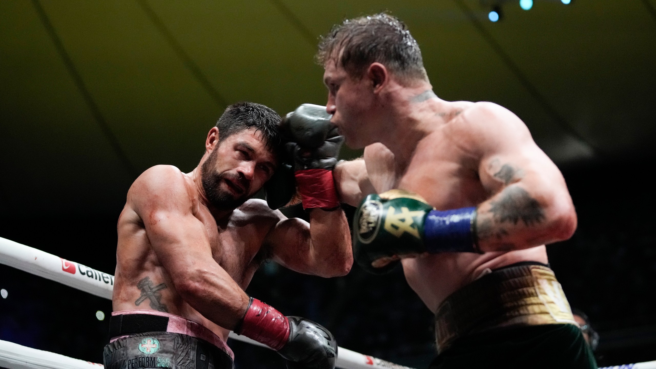 Saul "Canelo" Alvarez of Mexico, right, fights John Ryder of Britain in a super middleweight title boxing match at the Akron Stadium in Guadalajara, Mexico, Saturday, May 6, 2023. (AP Photo/Moises Castillo)