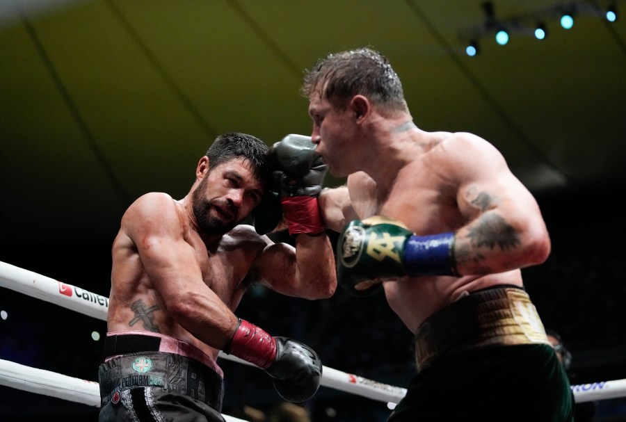 Saul "Canelo" Alvarez of Mexico, right, fights John Ryder of Britain in a super middleweight title boxing match at the Akron Stadium in Guadalajara, Mexico, Saturday, May 6, 2023. (AP Photo/Moises Castillo)