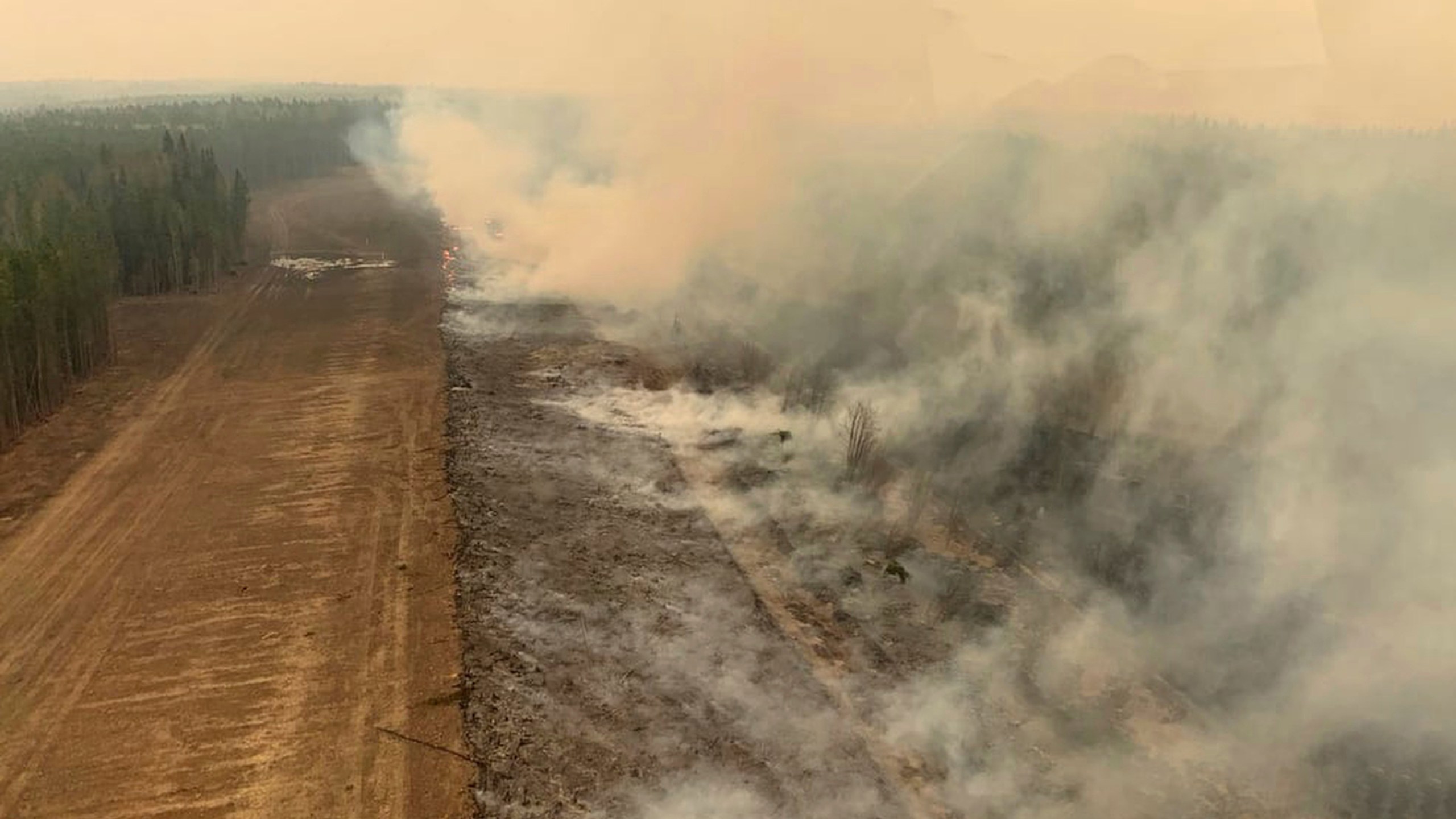 In this photo provided by the Government of Alberta Fire Service, a burned section of forest in the area near Edson, Alberta, smolders, Saturday, May 6, 2023. (Government of Alberta Fire Service/The Canadian Press via AP)