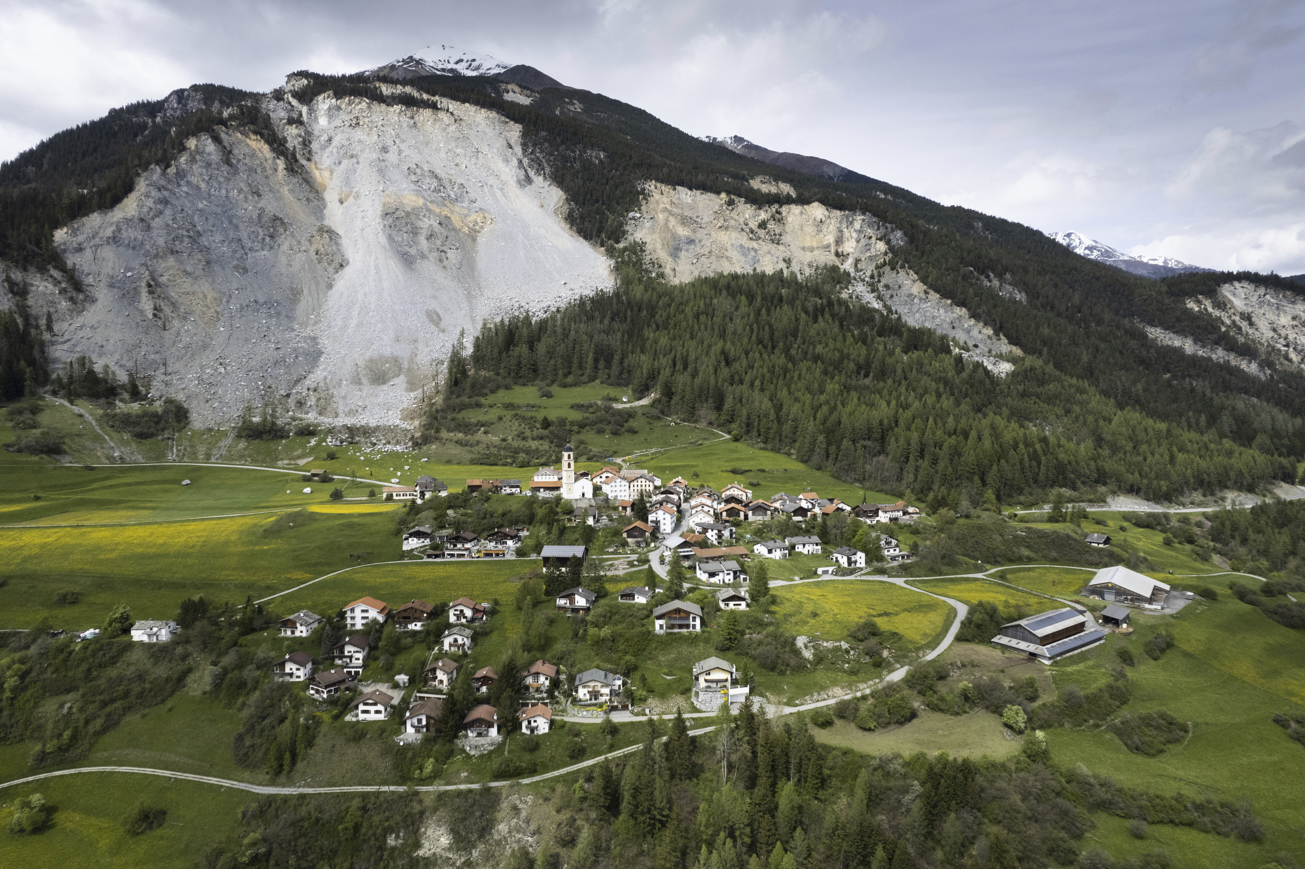 View of the village and the "Brienzer Rutsch", taken on Tuesday, 9 May 2023, in Brienz-Brinzauls, Switzerland. Authorities in eastern Switzerland have ordered residents of the tiny village of Brienz to evacuate by Friday evening because geology experts say a mass of 2 million cubic meters of Alpine rock looming overhead could break loose and spill down in coming weeks. (Gian Ehrenzeller/Keystone via AP)