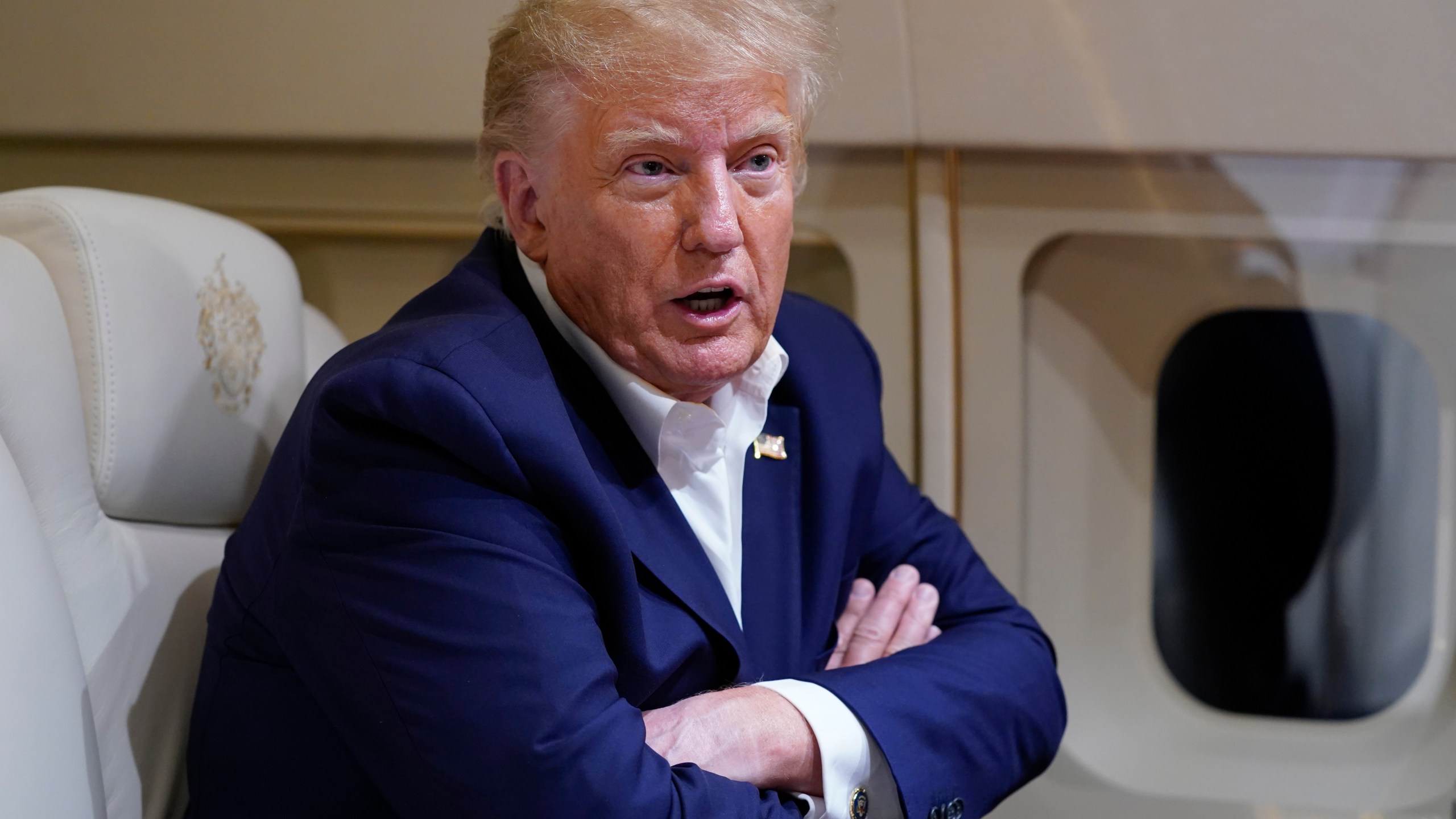 FILE - Former President Donald Trump speaks with reporters while in flight on his plane after a campaign rally at Waco Regional Airport, in Waco, Texas, March 25, 2023, while en route to West Palm Beach, Fla. (AP Photo/Evan Vucci, File)