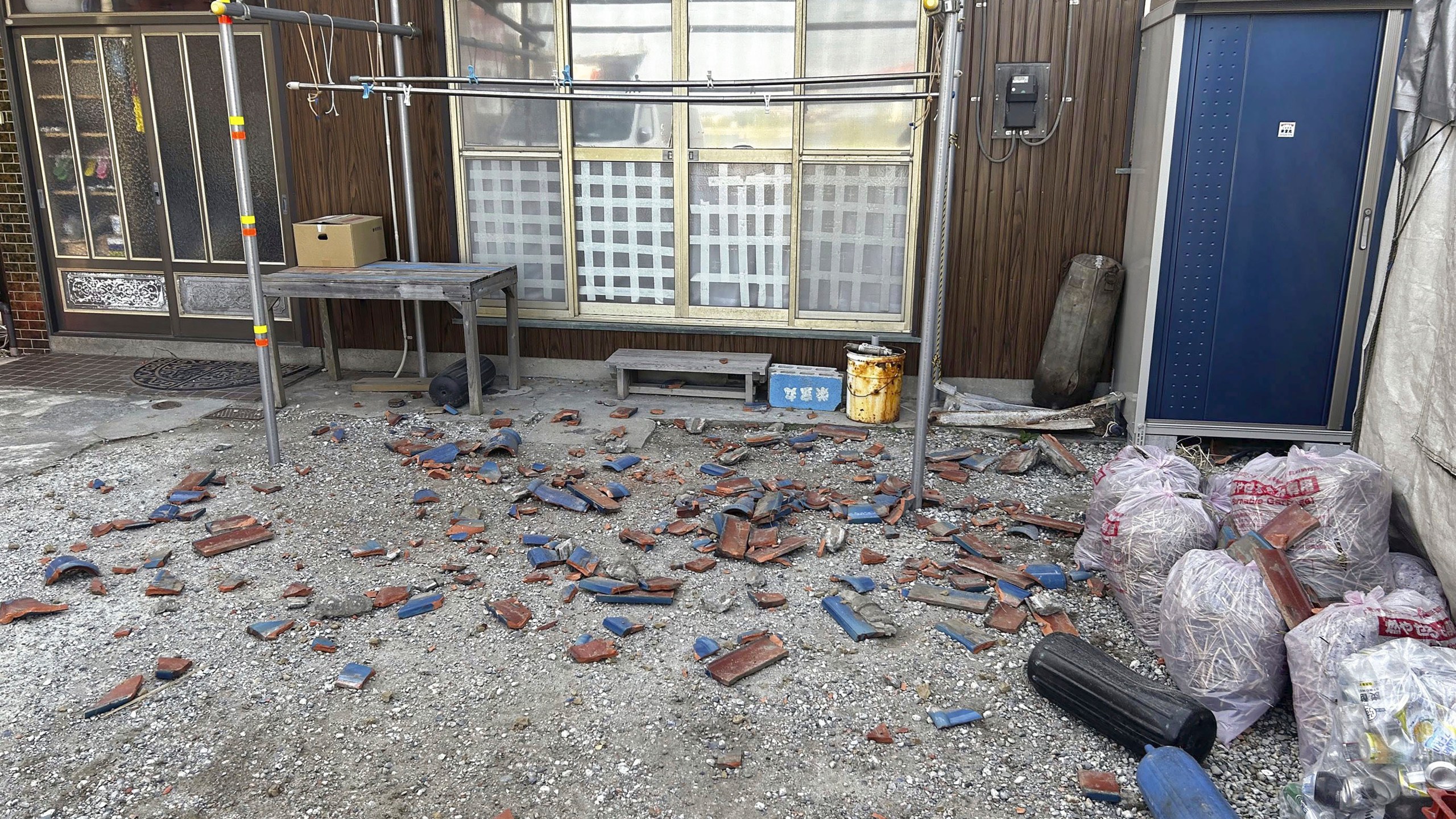 Tiles are scattered after an earthquake in Kisarazu, Chiba prefecture, near Tokyo Thursday, May 11, 2023. An earthquake shook Japan's capital, Tokyo, and surrounding areas on Thursday, injuring several people and causing minor damage, officials and media said. (Kyodo News via AP)