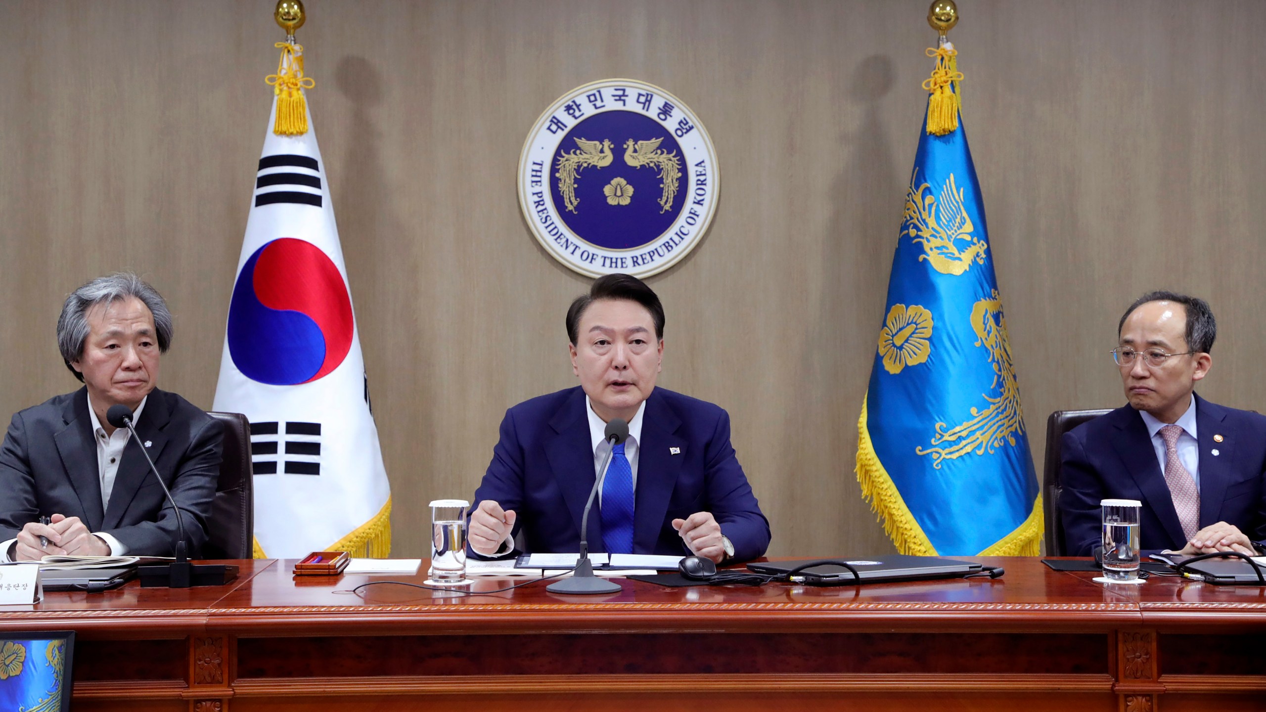 South Korean President Yoon Suk Yeol, center, speaks during a meeting of the Central Disaster and Safety Countermeasures Headquarters about measures to deal with the coronavirus pandemic at the presidential office in Seoul, South Korea, Thursday, May 11, 2023. South Korea will drop its COVID-19 quarantine requirements and end testing recommendations for international arrivals starting next month after the World Health Organization declared the end of the global health emergency. (Yonhap via AP)