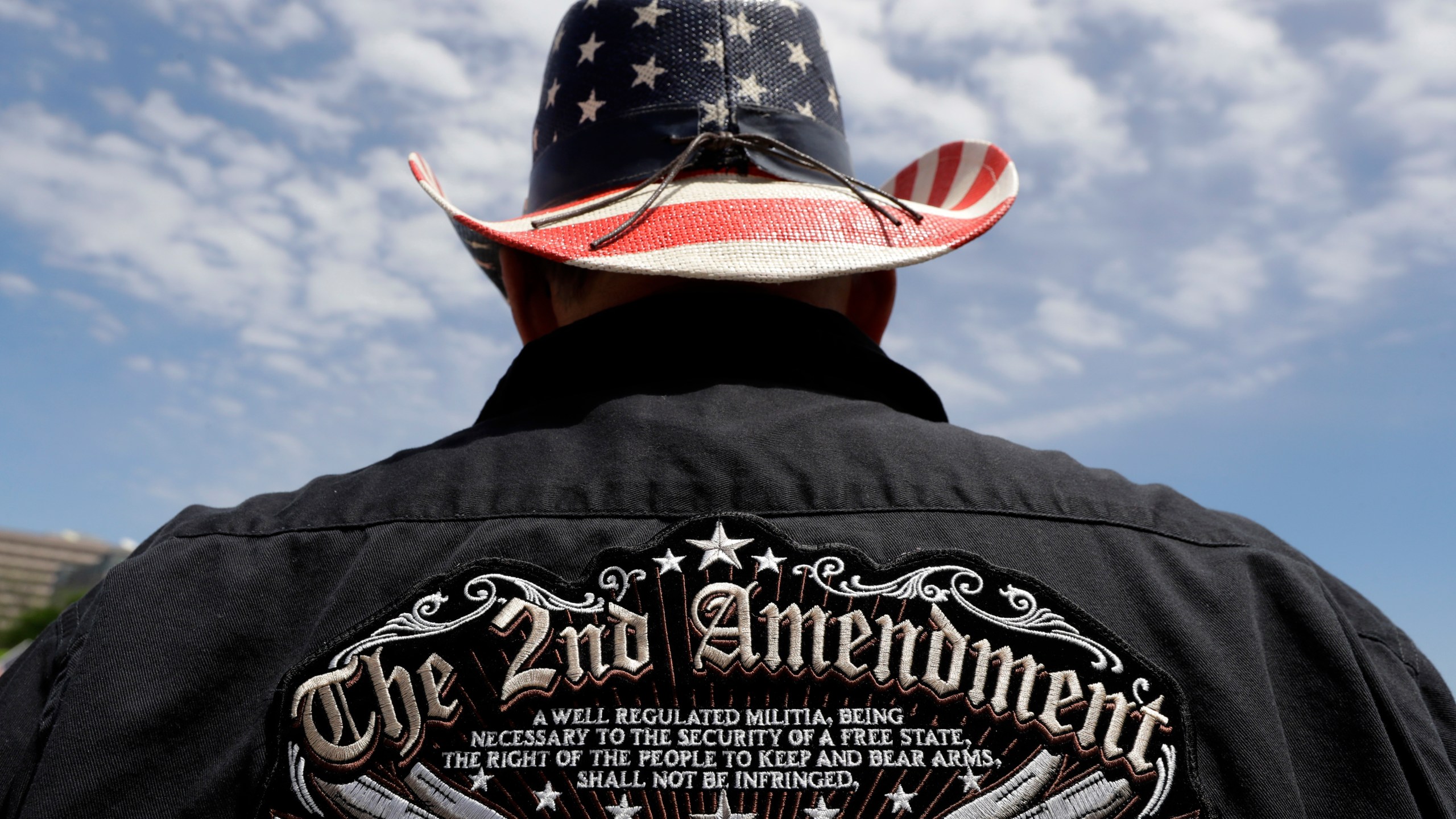 FILE - A man wears a patriotic-themed cowboy hat during a pro gun-rights rally at the Texas Capitol, April 14, 2018, in Austin, Texas. Guns have long been a part of Texas culture — both in the state’s mythology and in reality. But to equate the number of guns with the number of people killed by guns strikes some as a false equivalence. (AP Photo/Eric Gay, File)