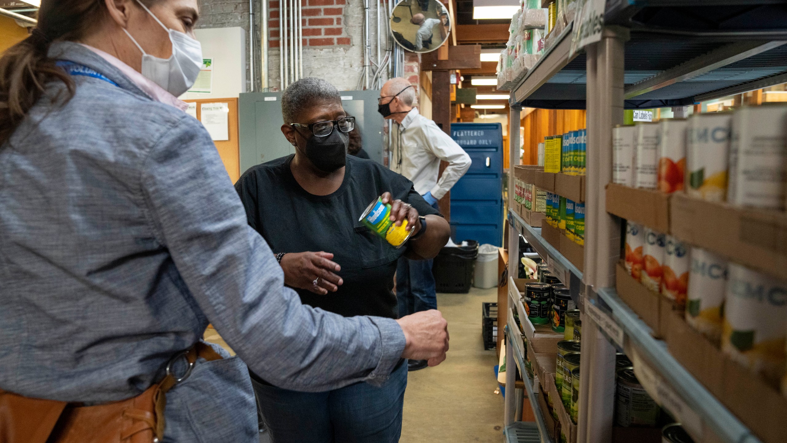 Helena Smith, center, of Washington, chooses a food item while shopping at Bread for the City, Wednesday, May 10, 2023, a food pantry in Washington. The formal end of the national Public Health Emergency on Thursday marks the end of several U.S. pandemic-era emergency support program, from extra food assistance to automatic enrollment in Medicaid. "I like this a lot because they give us a variety of fruit," says Smith, "instead of just cans." (AP Photo/Jacquelyn Martin)