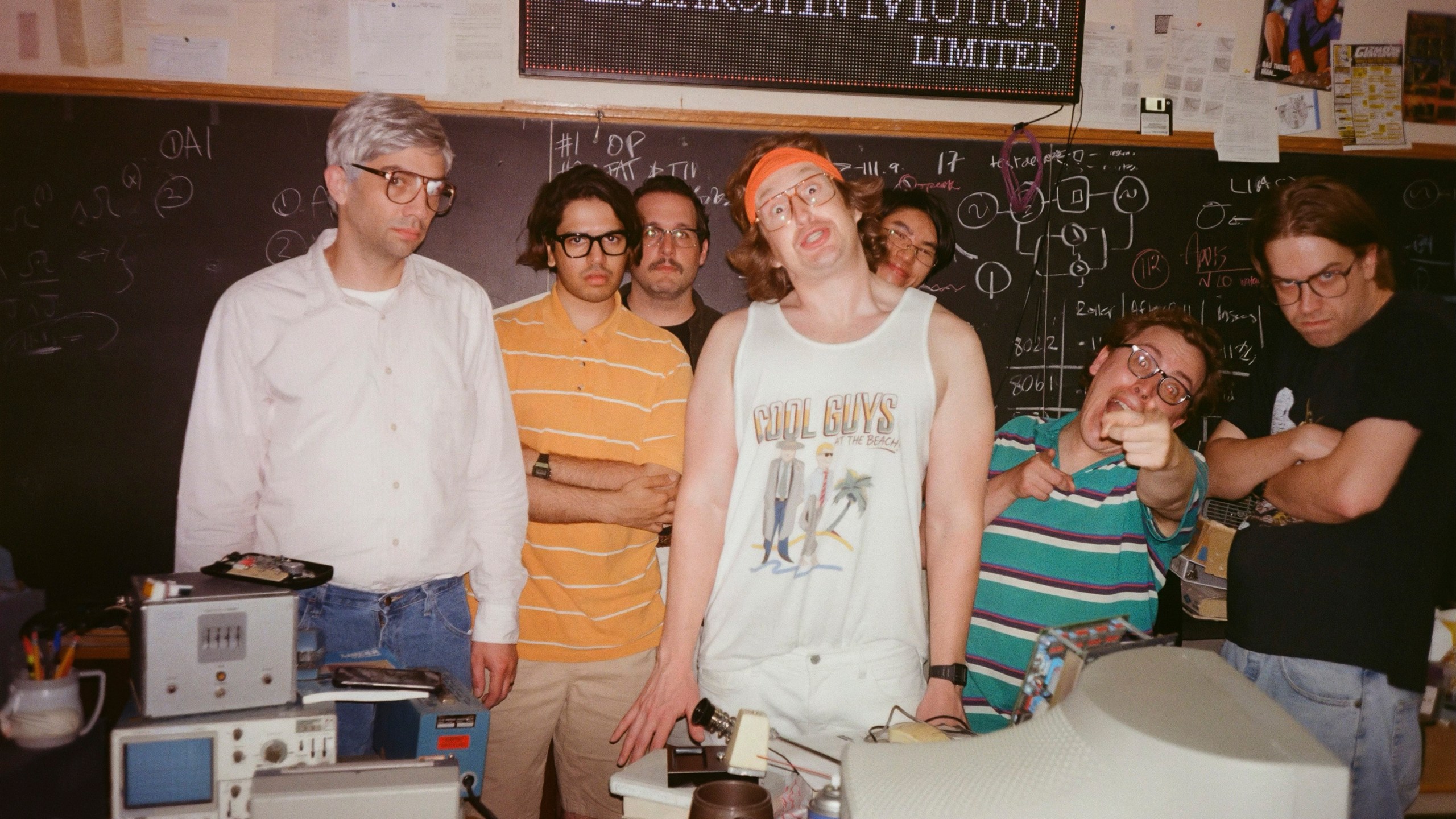 This image released by IFC Films shows Jay Baruchel, left, and actor-director Matt Johnson, center, with cast members on the set of "BlackBerry." (IFC Films via AP)