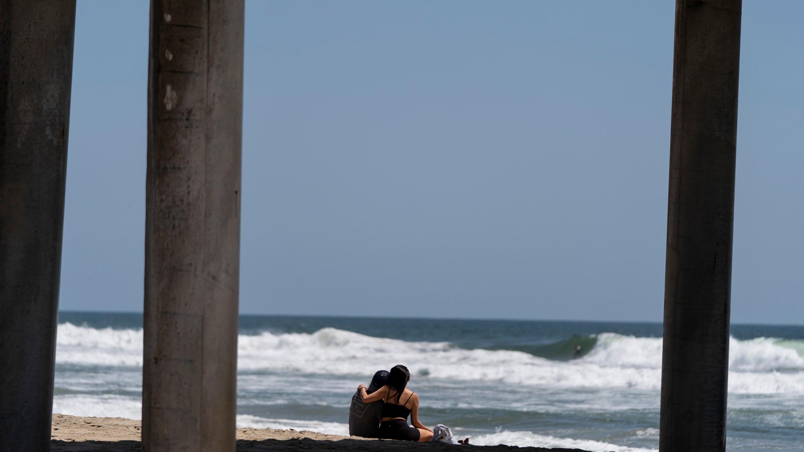 A young couple sit on the beach in Huntington Beach, Calif., Monday, May 8, 2023. For years, studies have shown a decline in the rates of American high school students having sex. That trend continued, not surprisingly, in the first years of the pandemic, according to a recent survey by the Centers for Disease Control and Prevention. The study found that 30% of teens in 2021 said they had ever had sex, down from 38% in 2019 and a huge drop from three decades ago when more than half of teens reported having sex. (AP Photo/Jae C. Hong)