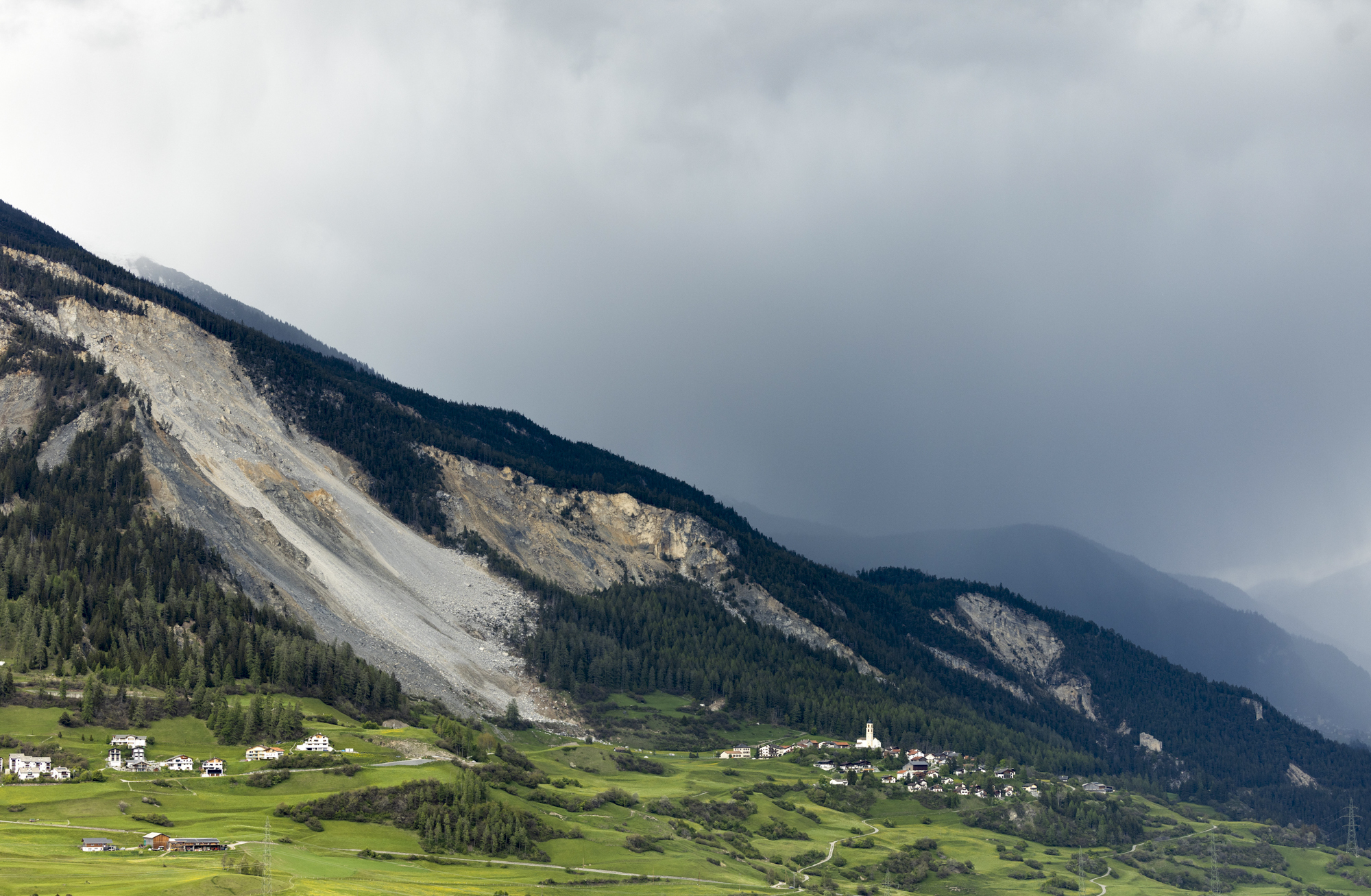 View of the village and the "Brienzer Rutsch", taken in Brienz-Brinzauls, Switzerland, Friday, May 12, 2023. Authorities in eastern Switzerland have ordered residents of the tiny village of Brienz to evacuate by Friday evening because geology experts say a mass of 2 million cubic meters of Alpine rock looming overhead could break loose and spill down in coming weeks. (AP Photo/Arnd Wiegmann)