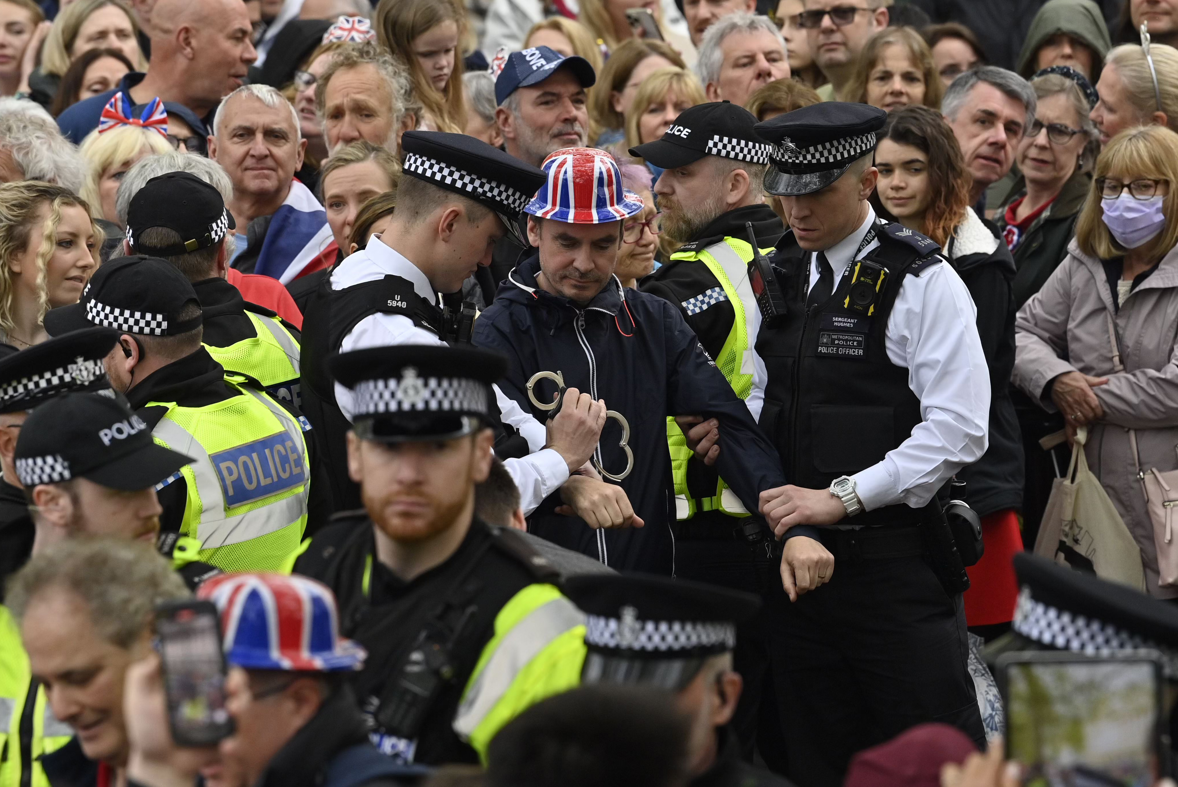 FILE - Protesters from climate protest group 'Just Stop Oil' are apprehended by police officers in the crowd close to where Britain's King Charles III will be crowned at Westminster Abbey, in London, Saturday, May 6, 2023. London’s top police officer on Friday, May 12, 2023 defended the department against complaints of a heavy-handed response to protesters during the coronation of King Charles III, saying his officers intervened to prevent “serious disruption and criminality.” (Justin Tallis/Pool Photo via AP, File)