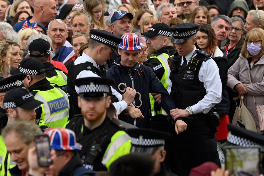 FILE - Protesters from climate protest group 'Just Stop Oil' are apprehended by police officers in the crowd close to where Britain's King Charles III will be crowned at Westminster Abbey, in London, Saturday, May 6, 2023. London’s top police officer on Friday, May 12, 2023 defended the department against complaints of a heavy-handed response to protesters during the coronation of King Charles III, saying his officers intervened to prevent “serious disruption and criminality.” (Justin Tallis/Pool Photo via AP, File)