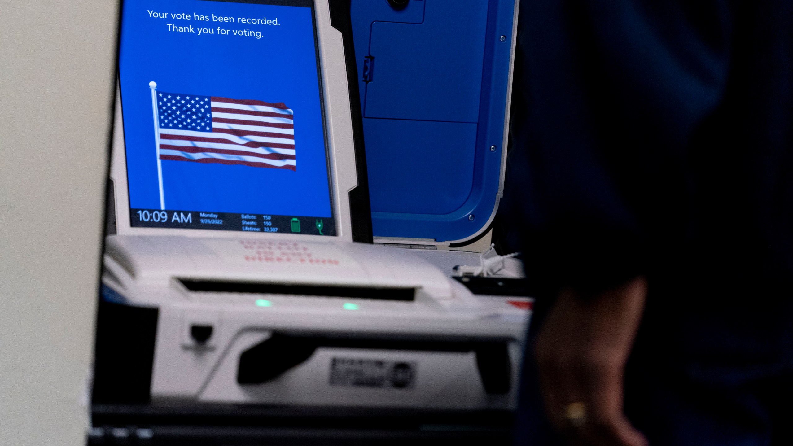 FILE - A voter submits their ballot at an early voting location in Alexandria, Va., Monday, Sept. 26, 2022. Election officials in Virginia have announced plans to withdraw the state from a bipartisan effort aimed at ensuring accurate voter lists and combating fraud that has been ensnared in conspiracy theories that have erupted since the 2020 presidential election. (AP Photo/Andrew Harnik, File)