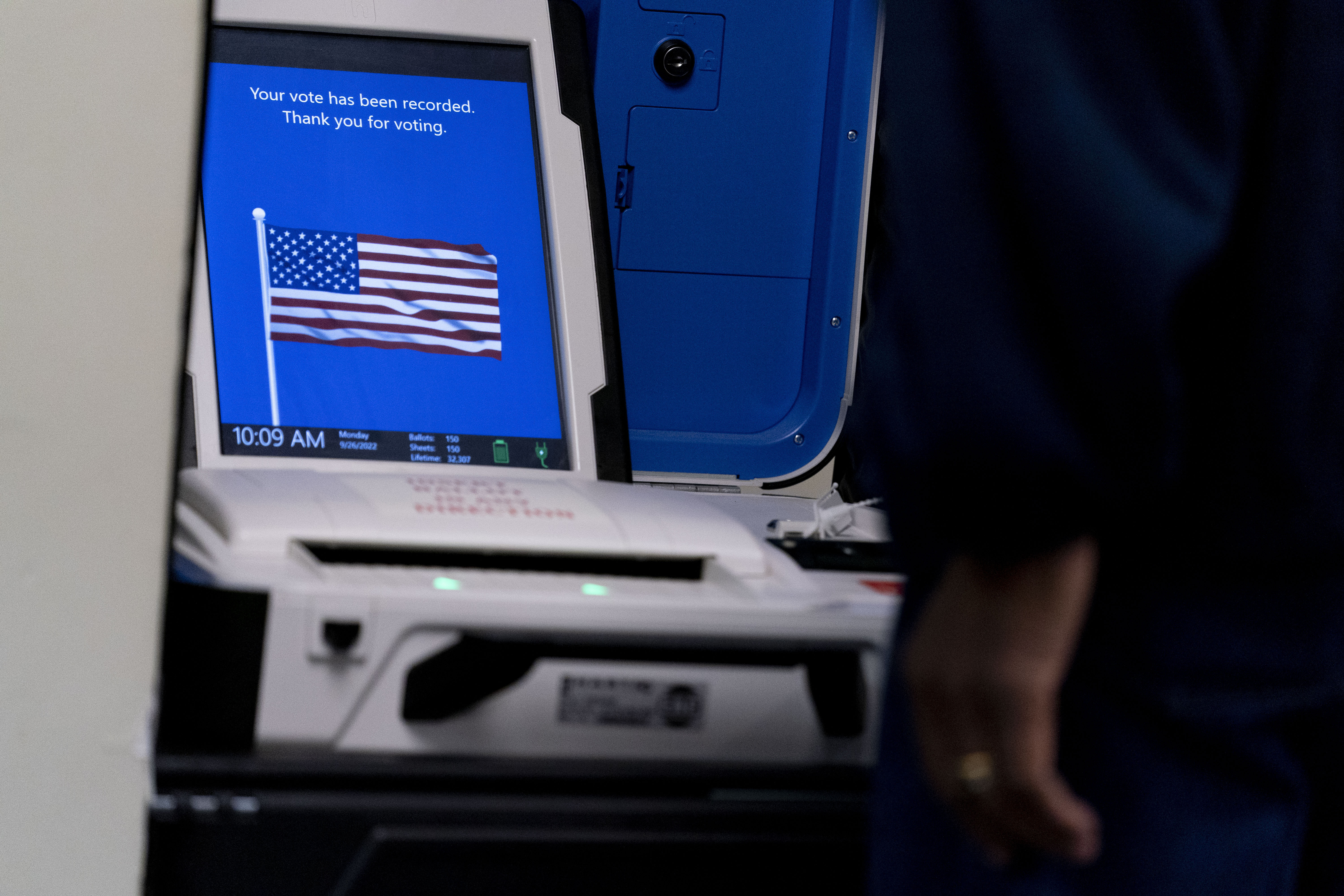 FILE - A voter submits their ballot at an early voting location in Alexandria, Va., Monday, Sept. 26, 2022. Election officials in Virginia have announced plans to withdraw the state from a bipartisan effort aimed at ensuring accurate voter lists and combating fraud that has been ensnared in conspiracy theories that have erupted since the 2020 presidential election. (AP Photo/Andrew Harnik, File)