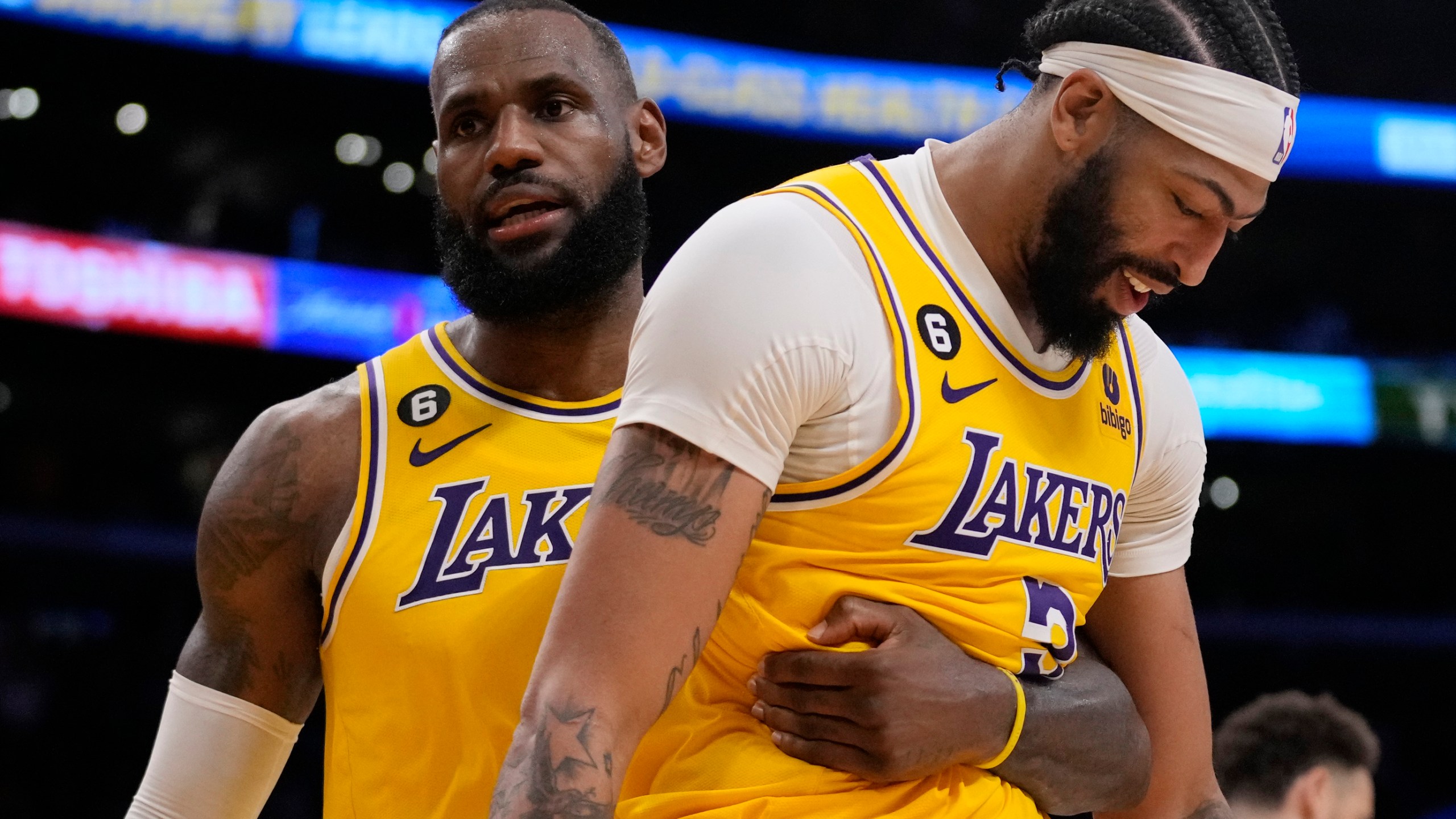 Los Angeles Lakers forward LeBron James, left, hugs forward Anthony Davis during the second half in Game 6 of an NBA basketball Western Conference semifinal series against the Golden State Warriors Friday, May 12, 2023, in Los Angeles. (AP Photo/Ashley Landis)