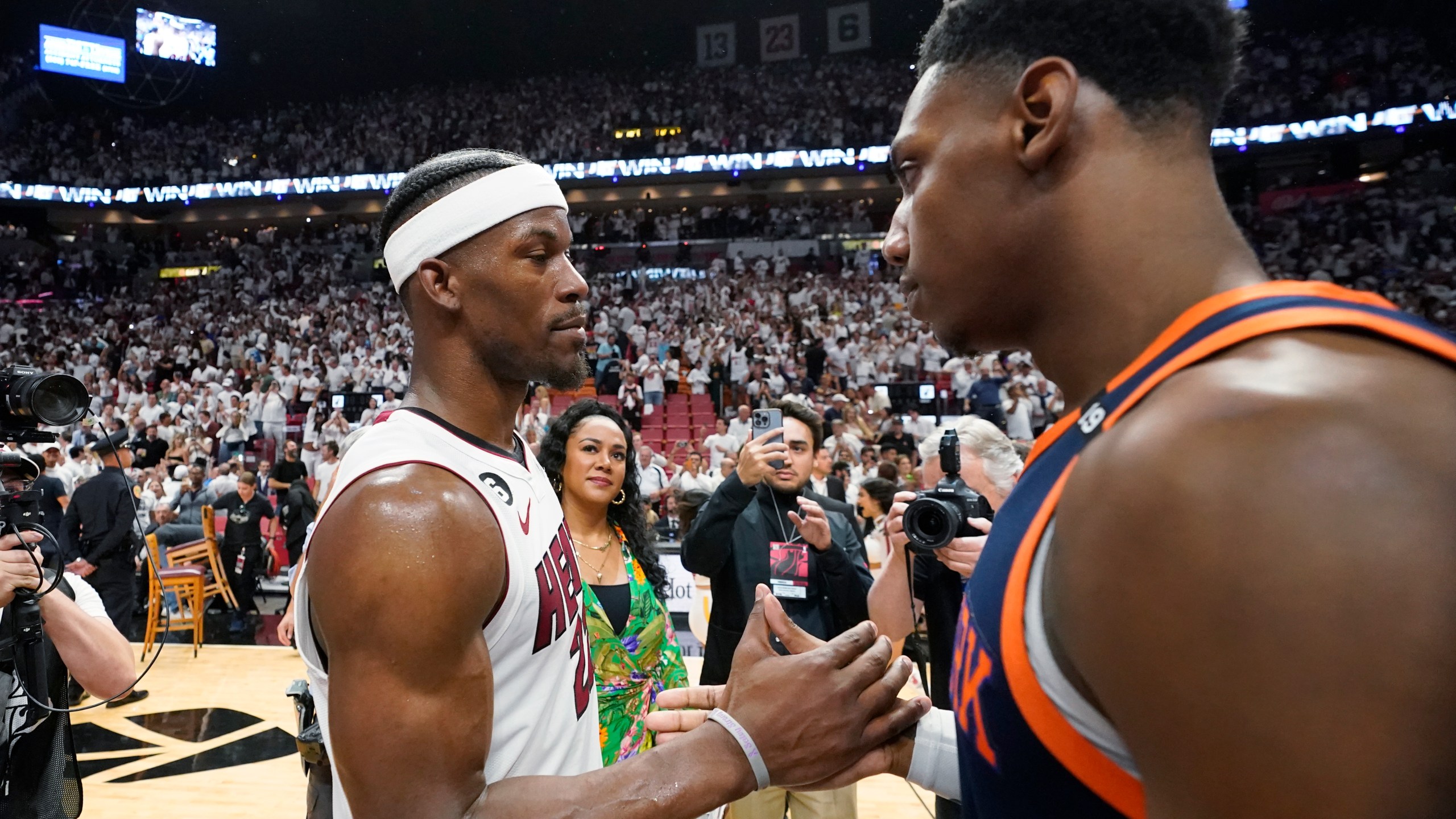 Miami Heat forward Jimmy Butler, left, and New York Knicks guard RJ Barrett congratulate each other after the Heat beat the Knicks 96-92 during Game 6 of an NBA basketball second-round playoff series, Friday, May 12, 2023, in Miami. (AP Photo/Wilfredo Lee)