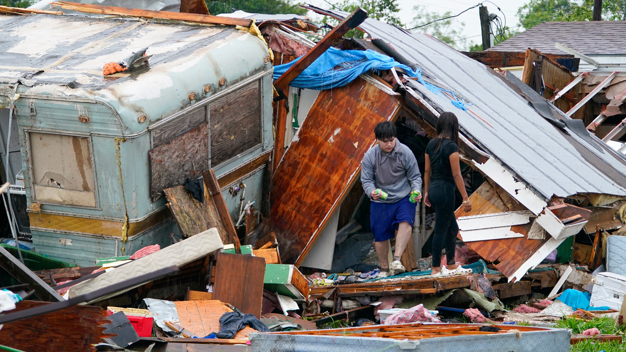 People salvage items from a home after a tornado hit Saturday, May 13, 2023, in the unincorporated community of Laguna Heights, Texas near South Padre Island. Authorities say one person was killed when a tornado struck the southernmost tip of Texas on the Gulf coast. (AP Photo/Julio Cortez)