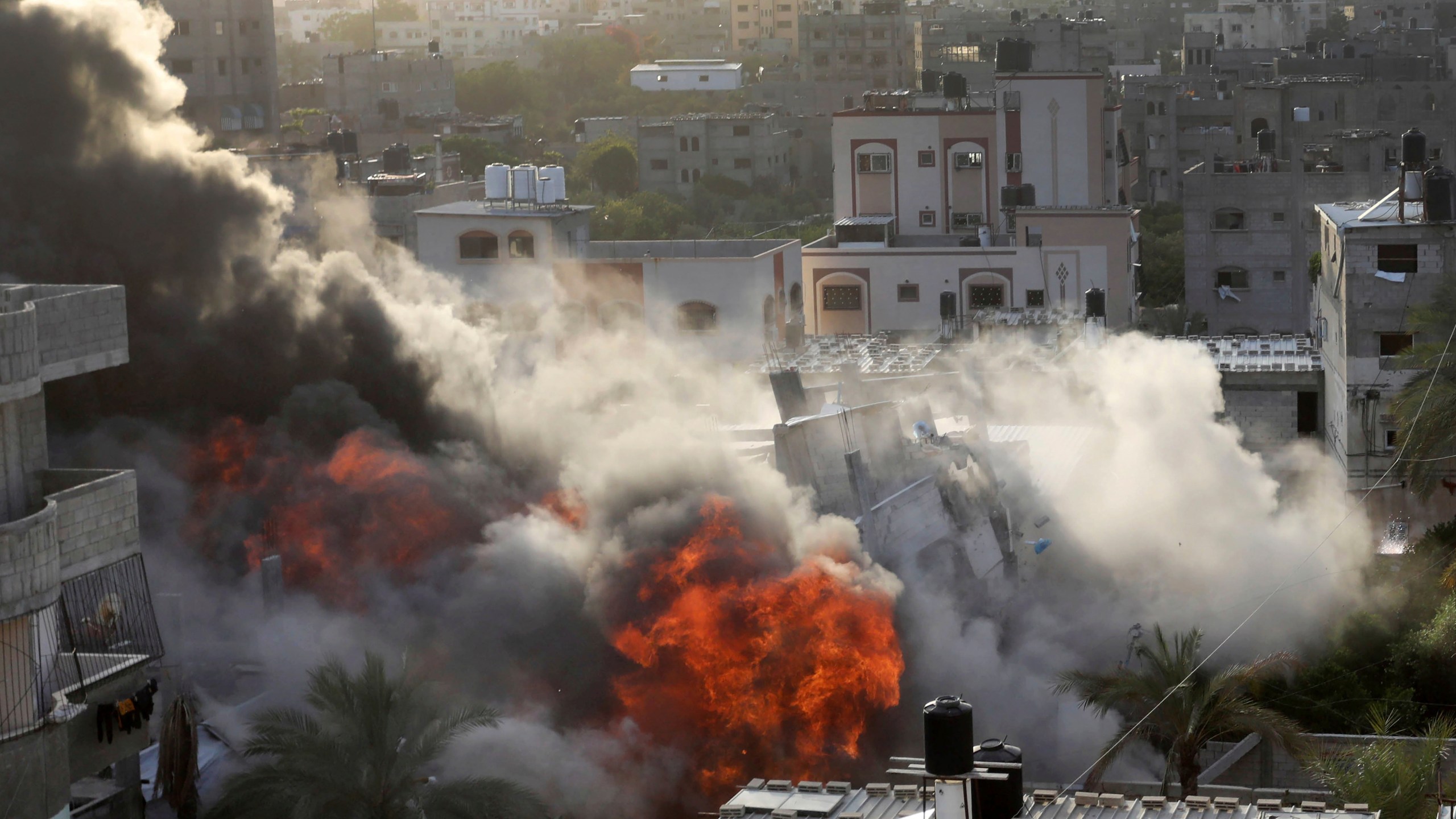 Smoke and fire rise from an explosion caused by an Israeli airstrike targeting a building in Gaza, Saturday, May 13, 2023. The building was owned by an Islamic Jihad official. (AP Photo/Ashraf Amra)