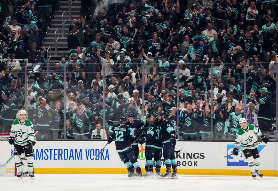 The Seattle Kraken celebrate a goal by right wing Eeli Tolvanen as Dallas Stars defenseman Esa Lindell, left, and center Wyatt Johnston (53) skate away during the second period of Game 6 of an NHL hockey Stanley Cup second-round playoff series Saturday, May 13, 2023, in Seattle. (AP Photo/Lindsey Wasson)