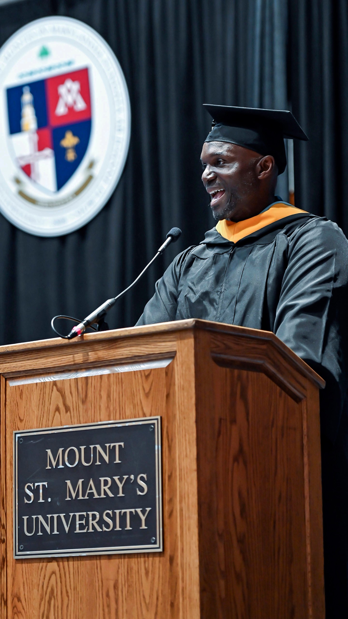 Tampa Bay Buccaneers head coach Todd Bowles speaks to the graduates and crowd at the 215th commencement exercise for of Mount St Mary's University, Saturday, May 13, 2023, in Emmitsburg, Md.. Bowles finished his degree in September of 2022 but wanted to walk the stage on Saturday. (Ric Dugan/The Frederick News-Post via AP)