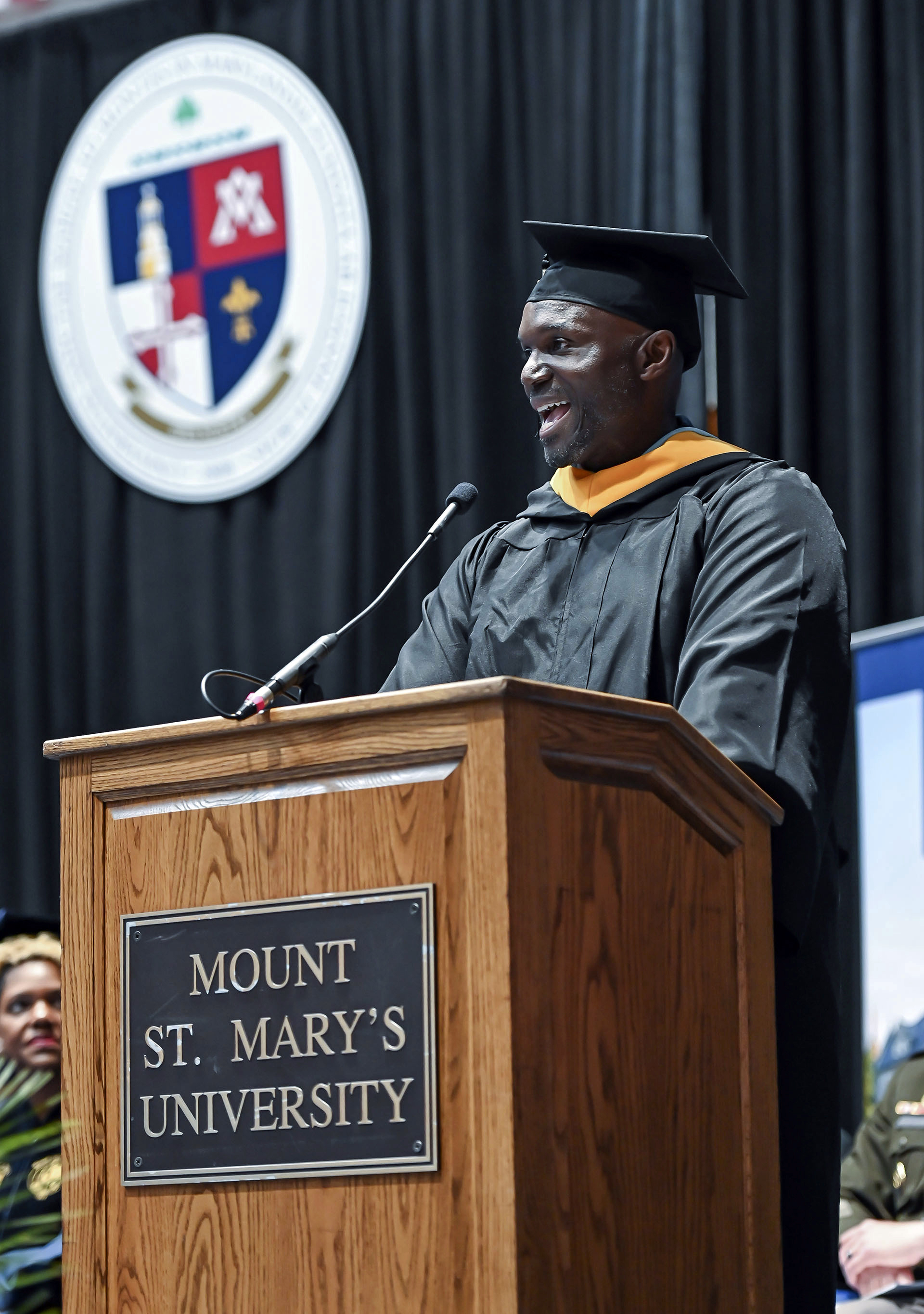 Tampa Bay Buccaneers head coach Todd Bowles speaks to the graduates and crowd at the 215th commencement exercise for of Mount St Mary's University, Saturday, May 13, 2023, in Emmitsburg, Md.. Bowles finished his degree in September of 2022 but wanted to walk the stage on Saturday. (Ric Dugan/The Frederick News-Post via AP)