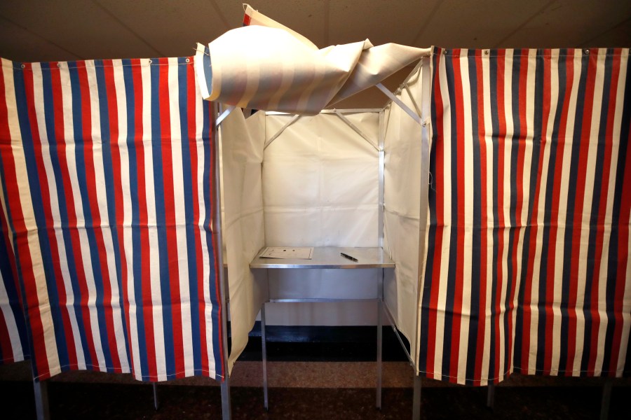 FILE - A booth is ready for a voter, Feb. 24, 2020, at City Hall in Cambridge, Mass., on the first morning of early voting in the state. (AP Photo/Elise Amendola, File)