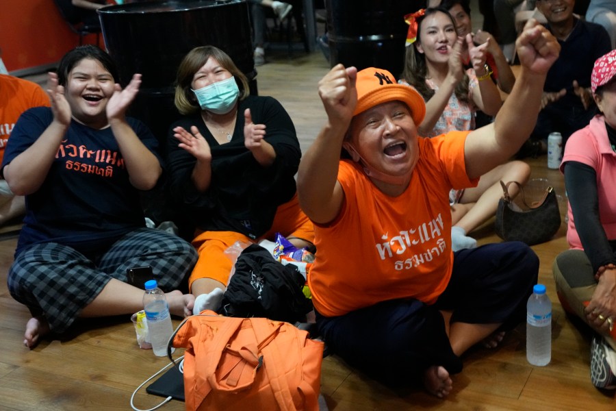 Supporters of Move Forward party cheer as they watch the counting of votes on television at Move Forward Party headquarters in Bangkok, Thailand, Sunday, May 14, 2023. Vote counting was underway Sunday in Thailand's general election, touted as a pivotal chance for change nine years after incumbent Prime Minister Prayuth Chan-ocha first came to power in a 2014 coup. (AP Photo/Sakchai Lalit)