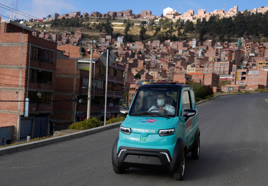 Dr. Carlos Ortuno drives a Bolivian-made, Quantum electric car to a house call, in La Paz, Bolivia, Wednesday, May 3, 2023. Launched in 2019, Quantum Motors has only sold 350 electric cars in Bolivia. But their founders recently received a boost from the German city of Bonn, which invested 50,000 euros to acquire six units in support of a local program that sends doctors to people's homes. (AP Photo/Juan Karita)